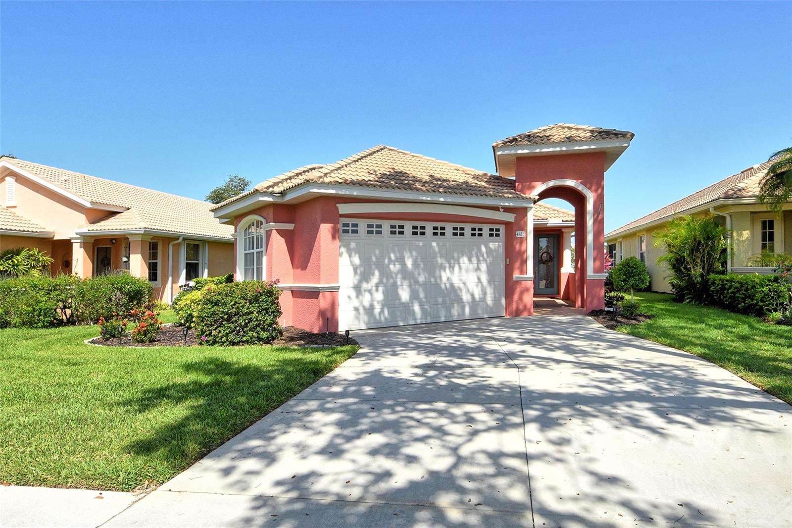 Welcome to maintenance-free living in the charming, GATED community of Villa Rosa, nestled in the highly desired Minimal Flood Hazard Zone X and located within an A-rated school district. This move-in-ready, one-level home offers 2 bedrooms, 2 bathrooms, and a versatile flex space that can serve as an office, den, or craft room. The thoughtfully designed split floor plan provides privacy, placing the expansive primary suite—with its serene lake views, tray ceiling, and large closets, dual vanities, walk-in shower, separate from the guest bedroom. Tall ceilings and an open layout enhance the home’s spacious, airy feel, making it an inviting retreat. The kitchen opens to the living area, perfect for entertaining, and the enclosed lanai with AC offers a tranquil spot to relax or dine al fresco. Enjoy the community’s heated pool, spa, clubhouse with a fitness center, and neighborly atmosphere. With yardwork and lake maintenance handled by the HOA, plus low HOA fees and no CDD, you’ll have more time to explore nearby attractions like Urfer Family Park, downtown Sarasota, world-class beaches, golf courses, and the UTC Mall. Why maintain your own pool when one is just steps away? This is the perfect blend of comfort, convenience, and carefree living—schedule your private showing today and make this must-see home yours!