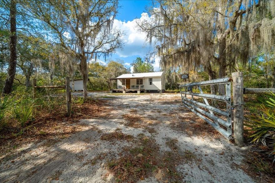 Escape to your own private retreat in the peaceful Hog Valley area—an outdoorsman’s dream surrounded by miles of untouched forest and just moments from the Ocklawaha River and Rodman Reservoir. Whether you love fishing, hunting, camping, or exploring ATV trails, this location offers endless adventure right outside your door. Situated on nearly half an acre, this fully fenced and gated property provides both privacy and space to enjoy the natural surroundings. A charming front porch welcomes you in—perfect for morning coffee or unwinding after a day outdoors. Inside, the home has been thoughtfully updated and is completely move-in ready. Enjoy fresh interior and exterior paint, new flooring, and an updated kitchen designed for both functionality and style. Modern LED light fixtures brighten every room, while added insulation enhances energy efficiency year-round. This property is being offered furnished, making it an ideal turnkey primary residence, weekend getaway, or income-producing rental. Major upgrades provide peace of mind, including a new water heater in 2025, metal roof that's been re-sealed in late 2025, and a new well installed in 2022 with durable block housing. Outside, a large storage shed with electricity offers plenty of room for tools, equipment, or recreational gear. If you’re looking for a quiet lifestyle surrounded by nature without sacrificing modern comforts, this gem delivers the perfect balance of seclusion, convenience, and adventure.