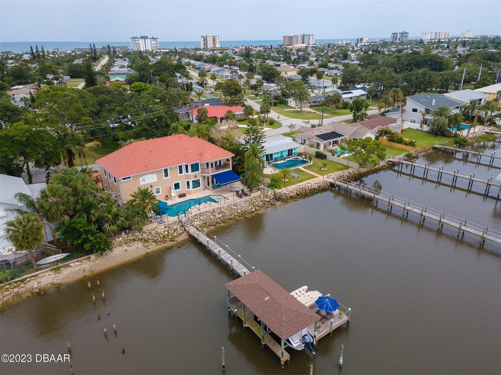 Rare opportunity to own an exclusive, beyond unique, Mediterranean style custom built, waterside home. Built to admire expansive intracoastal views, this home boasts meticulous attention to detail, unmatched quality and a thoughtfully considered floor plan offering a main level bedroom suite and multiple oversized windows highlighting views of Tomoka State Park and the Halifax River. At first glance, this homestead is a tropical sanctuary meant for privacy but it also offers abundant space and separate living areas for family, guests and intimate or large gatherings. Outdoor spaces showcase a resort like, beautifully landscaped yard and gardens, a salt water pool, inground spa, irrigation sprinkler and TIKI HUT, a long dock, slip with lift, electric and water. Other key elements of this property include a brick paver driveway with multiple parking spaces, a dual zoned air system, a security system with cameras, upgraded kitchen appliances and a wrought iron fenced in yard. Last note - the most unforgettable
owners suite is masterfully appointed with no detail forgotten. It is graced with a quaint seating area with a gas fireplace, a grande ensuite with custom built ins and an adjacent outdoor balcony. Come see this home - This is your opportunity to experience unique luxury not known by many, Don't miss it. ;Water: City