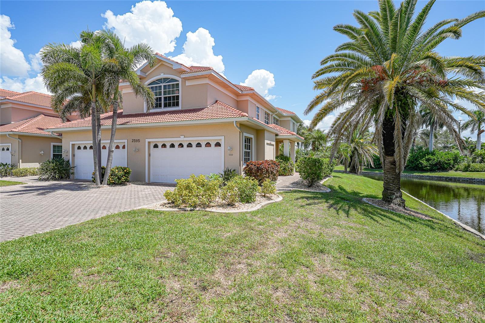 Impressive three bedroom plus den, three bathroom condo with a two-car garage, located in the desirable and upscale community of Tarpon Cove in beautiful Punta Gorda Isles. This executive residence offers the perfect blend of elegance and comfort, designed with an open and split bedroom floor plan. The two-story layout welcomes you on the first floor with a foyer and garage, where either the private elevator or a graceful staircase leads you to the second-floor living space.
The home is filled with natural light and showcases soaring vaulted and cathedral ceilings, hardwood floors in the main living areas and bedrooms, and plantation shutters throughout. The spacious great room opens seamlessly to a large lanai, complete with screens, vinyl windows, and a tranquil view of the lake and fountain. A separate dining room provides the perfect setting for formal meals, while French doors lead into a generous den.
The well-appointed kitchen features solid surface counters, white cabinetry, stainless steel appliances, and a dining area. An island topped with granite not only offers additional workspace but also provides extra storage. The master suite is a true retreat, with an expansive California walk-in closet and a private bathroom offering dual sinks, a soaking tub, and a separate walk-in shower. Two large guest bedrooms provide comfortable accommodations, one with its own private bath. The third full bathroom, located in the hallway, includes a tub/shower combination. The third bedroom is currently used as an office, adding flexibility to the space.
For added convenience, the inside laundry room is equipped with a washer, dryer, sink, and even a refrigerator. Outside, the Tarpon Cove community is beautifully maintained with lush tropical landscaping and outstanding amenities, including a swimming pool, inground spa, and a clubhouse with kitchen and fitness equipment. The location is ideal—just minutes from Fishermen’s Village, downtown Punta Gorda, boutique shopping, dining, and the city’s popular waterfront parks.