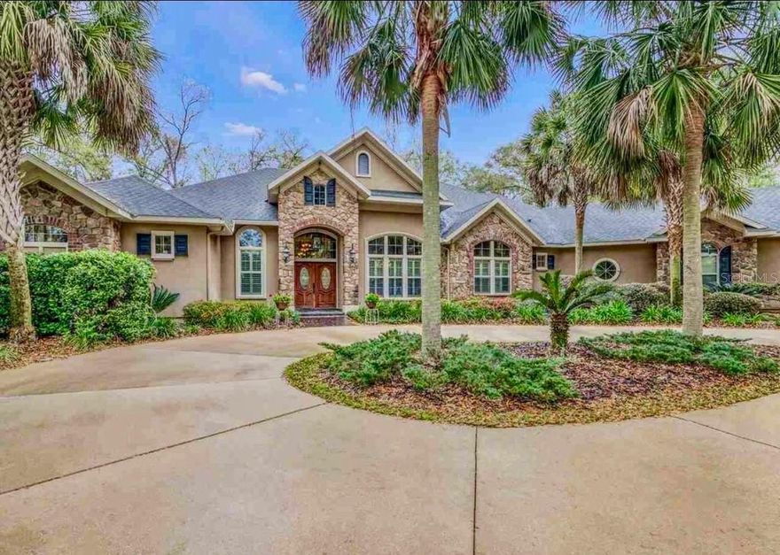 One or more photo(s) has been virtually staged. Welcome to Shannon Woods. This expansive custom residence sits on a 2.43-acre estate lot offering privacy and space. The home includes four bedroom suites and 4.5 baths, along with two separate studies, formal living and dining room, family room, breakfast nook and a generous great room. Step outside to more than 2,000 sq. ft. of luxury outdoor living, complete with a screened saltwater pool and spa, fire pit and a resort-inspired summer kitchen and bar—perfect for year-round entertaining. The kitchen offers stainless steel appliances, Bordeaux maple cabinetry and golden wave granite counters. The primary suite has a two-sided fireplace, bay window overlooking the pool, tray ceiling with cove lighting, surround sound, jetted soaking tub and an expansive walk-in closet area. Throughout the home you’ll find travertine tile, rustic antique wood flooring and detailed 5¼-inch crown molding. Additional highlights include another room with a fireplace, structured wiring for surround sound, three HVAC systems, a sprinkler system, whole-house generator and a free-form pool that can be operated by wireless remote or panel. The property offers a quiet setting with full perimeter cross-fencing, a gated entrance, a circular driveway and a three-car garage. With a voluntary HOA and no RV storage restrictions.  Conveniently located with quick access to Newberry Road, Archer Road and 24th Avenue, the home is zoned for highly rated public schools and just minutes from Haile Village Publix Center, Queen of Peace and Oak Hall School. I-75 is a short drive away.