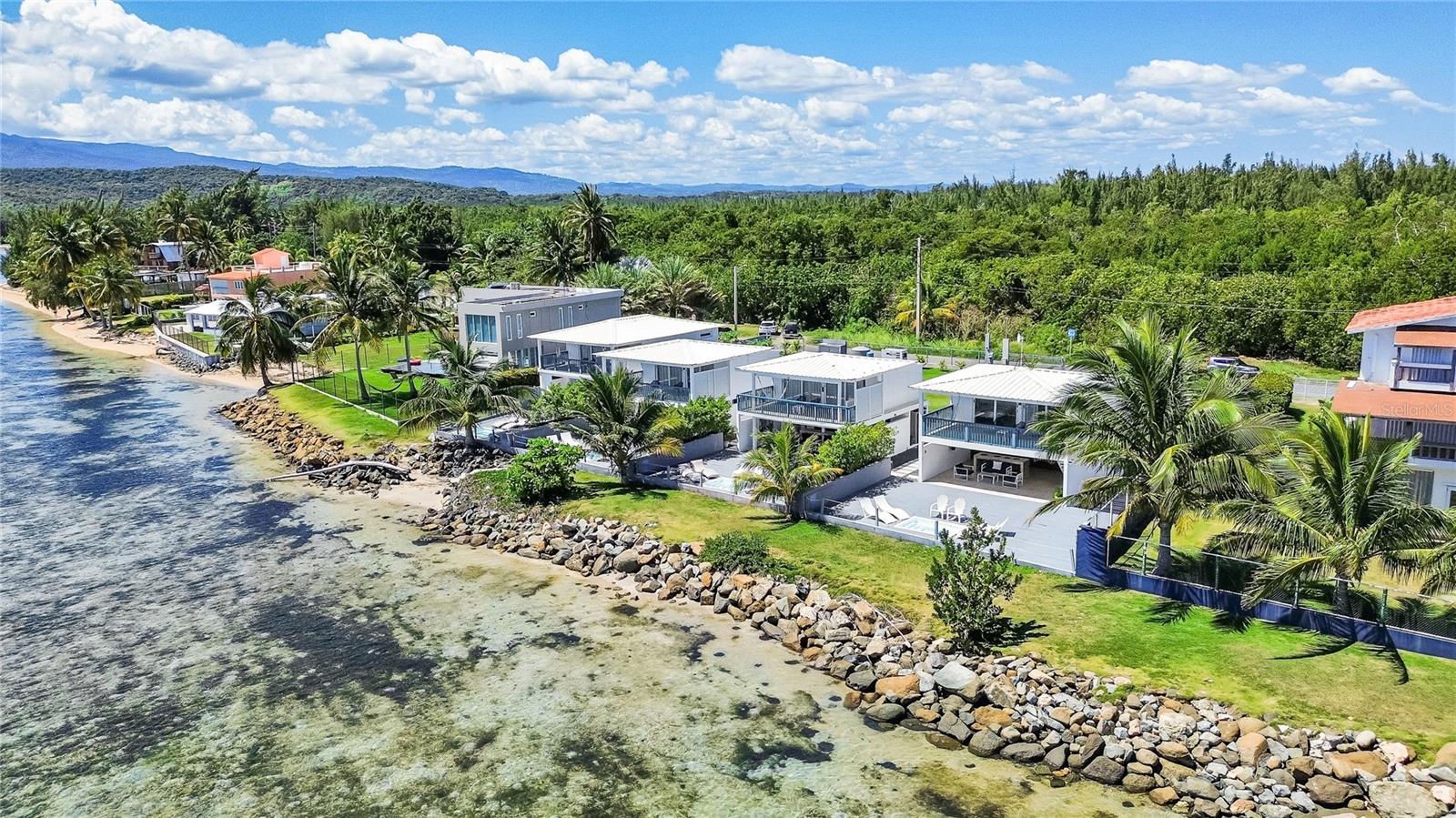 Located in Las Picúas, RÃo Grande, this stunning beachfront estate is a true tropical paradise, offering four separate villas within a gated complex, each with direct beach access. Spanning 6,300 sq. ft. approximately and 2,066 sq meters, the property features a total of 9 bedrooms, 6 full bathrooms, and 6 half bathrooms. The largest, Villa Marcela, boasts 1,800 sq ft aprox., three bedrooms and three and a half bathrooms, with a first floor featuring one bedroom with a full bathroom, a half bath, a fully equipped kitchen, a terrace with a jacuzzi, and a BBQ, while the second floor includes two additional bedrooms, each with its own full bathroom, and a private deck with breathtaking ocean views. Villa Lorena, Villa Manuela, and Villa Renata each boast 1,500 sq ft aprox. and have two bedrooms and three bathrooms (one full, two half), with a first floor featuring a full bathroom, kitchen, terrace with a jacuzzi and BBQ, and a second floor with two bedrooms, each with a half bathroom, plus a deck overlooking the beach. Additional amenities include a generator, private parking, washer and dryer for housekeeping, and all villas come fully furnished with modern décor. Currently generating income. Whether as a luxury residence, vacation rental, or boutique hospitality investment, this exclusive beachfront retreat offers the perfect blend of comfort, style, and income potential in one of Puerto Rico’s most desirable coastal locations.
