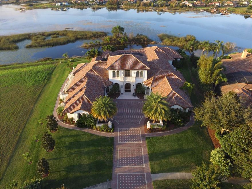 ESTATE SALE, full renovation needed.  Introducing a waterfront masterpiece estate in a truly unique setting--with lake frontage in both the front and rear of this exquisite home in the gated Isles of Lake Hancock community. 
This stunning custom-built home offers expansive living spaces, and a flow designed to take advantage of Florida's outdoors, with the primary suite, living room, great room all opening to the large, covered lanai and screen enclosed lakeside pool. The master suite enjoys complete privacy from the rest of the house. Masterfully crafted by a top MCBC builder.
Lake Hancock is a chain of three lakes availing pristine waters with miles of shoreline for boating and is a water sports paradise--famous for its ideal water skiing conditions, there are two slalom courses on the lake. The Hamlin town center plans include docks for water access to restaurants, shops and a movie theater. All while only ten minutes from Disney, and in close proximity to downtown Winter Garden, Windermere, and the world-famous attractions of Orlando. Come and see why this very private gated oasis has seen such little turnover, enjoying unmatched tranquility while just minutes from so much.  Estate sale, no Seller Disclosure available.