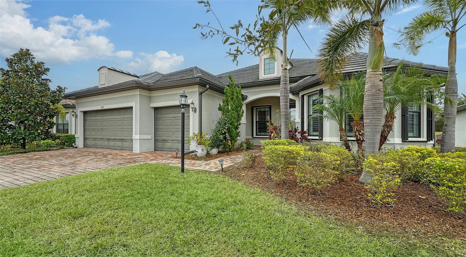 Come see this lovely home located in the gated 55+ Del Webb community in Lakewood Ranch. This popular Pinnacle model offers 3 bedrooms, 3 baths, a den, and gourmet kitchen with many built-ins. The zero corner slider leads to the screened lanai -- a great place where you can enjoy your morning coffee, relax, and entertain guests. The home offers 2488 square feet of living space along with a three-car garage (2 cars plus golf cart). The living areas have tiled floors and crown molding. Bedrooms have carpet. The spacious primary bedroom and ensuite bath has a spacious walk-in closet, large shower, and vanity with dual sinks. The open floor plan has a large gathering area adjacent to the spacious gourmet kitchen, and dinette. The kitchen countertops are quartz with white cabinetry and stainless steel appliances. There is a spacious walk-in pantry. A large island with sink, work space, breakfast bar separate the kitchen from the great room. At one end of the kitchen the dining area has easy access to the lanai. The laundry room has a utility sink and cabinetry along one wall. The home has plantation shutters throughout and hurricane shutters on the windows and doors. The 28,000 square foot Clubhouse is located within walking distance or a short drive. The Clubhouse offers numerous amenities, including, but not limited to a resort-style pool, state-of-the-art fitness center, pickleball and tennis courts, and game rooms. The Sailfish Bar and Grill restaurant offers indoor-outdoor waterfront dining. Del Webb at Lakewood Ranch is located within minutes of Lakewood Ranch Main Street and I-75 for easy access to Benderson Park, UTC shopping, restaurants, and entertainment. It is also just a short distance to Downtown Sarasota, St. Armands, and the beaches.