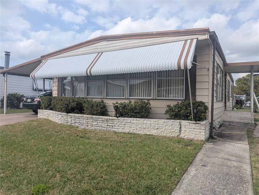 Charming two bedroom two bath home with lots of natural lighting in the living and dining areas.  The kitchen features lots of countertop space and is perfect for someone who enjoys cooking.  The primary bedroom offers an en suite bathroom and the second bedroom is perfect for guests or a home office.  Both bedrooms offer walk in closets.  The flooring in the living room and dining room has been updated.  The electric panel has been updated and the tankless water heater is less than 5 years old. This home has an storage area off the carport that houses the washer and dryer. Lakeside Hills Estates offers a clubhouse, library, kitchen, fitness room, craft room, workshop, shuffleboard pool and hot tub.  The clubhouse overlooks a lake and features a fishing dock. The HOA fees include cable, internet, water, sewer and lawn care.