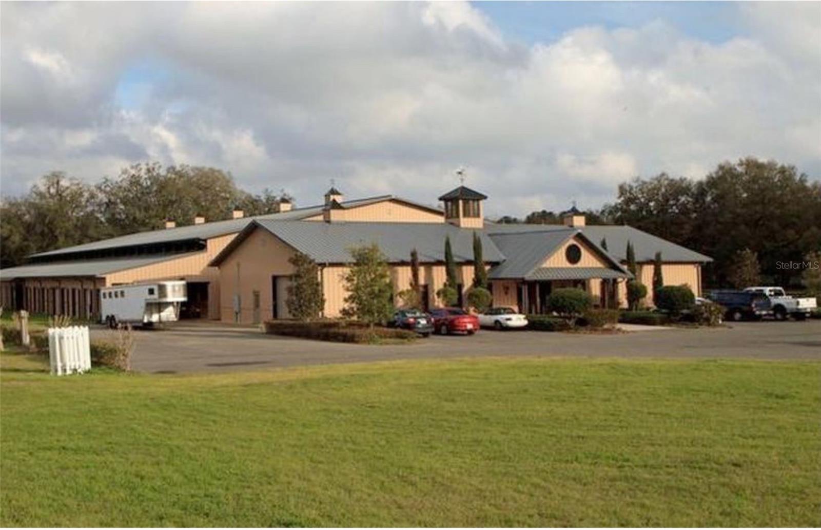 Welcome to a one-of-a-kind dream farm— 35 acres a true equestrian paradise just 10 minutes from WEC and 15 minutes from HITS! Designed with the professional rider and trainer in mind, this extraordinary property offers top-tier facilities for training, boarding, clinics, and horse sales—regardless of your discipline. Whether you’re looking to host world-class events, train at a competitive level, or develop a high-performing equestrian business, this farm has it all.
At the heart of the property is a 100’ x 200’ covered arena with premium GGT footing, surrounded by 30 stalls, with an additional 21 outdoor stalls for maximum flexibility. Trainers will appreciate two covered round pens 60’, horse walker for up to six horses, grass jumping arena—perfect for private training sessions or client clinics and 20 Acres of trail behind paddocks.
This farm has been thoughtfully designed with functionality and comfort in mind: climate-controlled viewing areas are available both upstairs and downstairs, a media room is perfect for showcasing sale horses or reviewing lessons, and there are 5 licensed RV hookups for visiting clients or guests.
Enjoy the ease of a smart barn automation system, which allows you to control the fly spray system, lighting, and music right from your phone. The property is also equipped with Starlink satellite internet, tack rooms, multiple wash stalls, and a commercial-grade water truck for efficient property maintenance.
Need accommodations? No problem—the property includes a 3-bedroom, 2-bathroom residence, ideal for hosting guests, clients, or live-in staff.
Beyond its beauty and functionality, this farm meets the essential criteria professional equestrian trainers seek:
• Complete and secure infrastructure, including a covered arena, spacious stalls, round pens, and functional workspaces.
• Size and layout that support ample turnout, expansion opportunities, and efficient movement between facilities.
• Prime location in the heart of the equestrian circuit—close to shows, vets, feed suppliers, and clientele.
• Reliable water systems, excellent drainage, and high-quality soil for healthy pastures and safe footing.
• Proper zoning with no HOA or subdivision restrictions—ideal for boarding, clinics, and training operations.
• Strong financial potential, both as a sound investment and an income-generating business through boarding, lessons, clinics, or breeding.
• Flexibility for future growth, with the ability to scale services, expand facilities, or adapt to changing business needs.
This isn’t just a property—it’s an equestrian lifestyle destination, thoughtfully built for performance, comfort, and long-term success.
Opportunities like this are truly rare! Schedule your private tour today and experience it in person.
