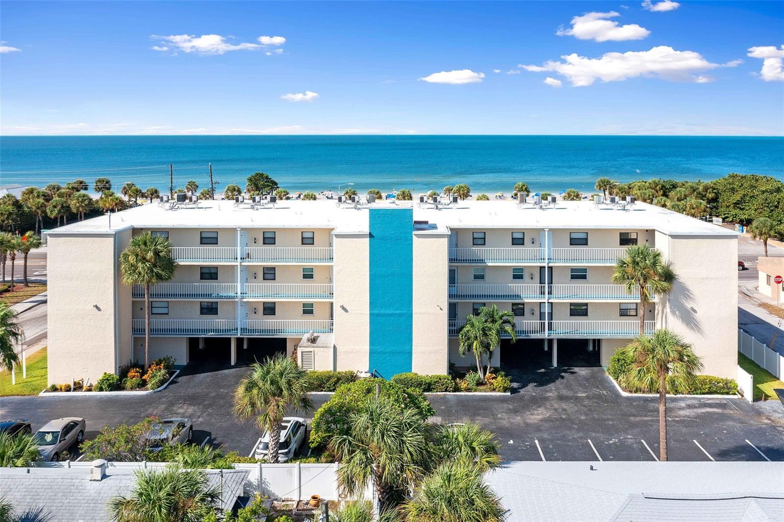 Welcome to your Gulf Coast retreat! This 2-bedroom, 2-bathroom end-unit condominium offers the perfect blend of coastal elegance and modern comfort. Just steps from the sparkling white sands, this condominium unit offers unobstructed Gulf views, with the land across the street preserved as a county park—ensuring your vistas remain serene and uninterrupted. Step inside to an open, airy floorplan where the kitchen flows seamlessly into the dining and living area - ideal for entertaining or relaxing while watching the waves. The corner location brings extra natural light and privacy. Both bedrooms provide peaceful retreats with ample closet space, while the primary suite features an ensuite bath and Gulf views for your personal sanctuary. The highlight is the expansive balcony - your private perch to enjoy the coastal breeze, admire the surf, and savor sunsets that paint the sky in brilliant shades of pink and gold. Enjoy amenities just steps from your door: a heated pool, reserved under building parking, and elevator access for effortless living. Beyond your home, explore the nearby dining, beach bars, and charming shops of John’s Pass Village and Boardwalk. Perfect for full-time living or as a vacation rental, this condo offers a 5-day minimum rental option - an excellent opportunity to share your slice of paradise. Don’t miss this chance to own a coastal haven where every day feels like a getaway. Schedule your private showing today and experience Gulf Coast living at its finest!