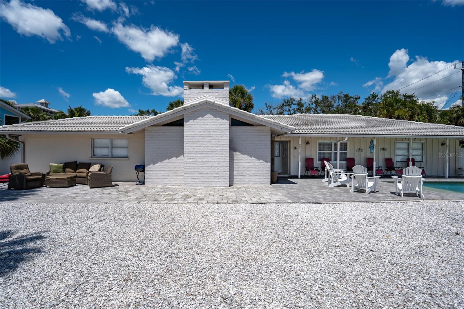 Once in a lifetime opportunity for a turnkey destination vacation home OR a rare short-term rental with high income production capacity! This Siesta Key, canal front, 3-bed 2-bath, coastal style home is absolutely gorgeous from the minute you walk in the door, to the moment you are on the back patio grilling some steaks, all the way until you are enjoying an after-dinner drink by the heated in-ground pool! Completely renovated with modern touches, an unforgettable kitchen, spacious cathedral vaulted ceilings, as well as a brand new shingle roof to come this summer with built-in and paid for solar panels to keep your utility costs low! Easy, no bridge, access to the bay via canal, but you’re also only a short walk from Crescent Beach! If you’re looking for fun in the Siesta Key Village, you can take a short drive, a relaxing bike ride, or even the free island trolley for some oysters and crab legs whenever you like!
The true rarity of this home, however, is that unlike the other homes around the key near the village, this property allows legal short-term rentals for less than 7 days due to its zoning! Start making money the minute you close! During the two years when it was being rented full-time, 2021 and 2022, this property was a Siesta Key gold mine and nearly made $200,000 in short-term rentals alone! You can keep this gem for yourself and enjoy easy access to one of the world’s most beautiful beaches, or you can claim it as an investment that will bring in revenue immediately; that's up to you!