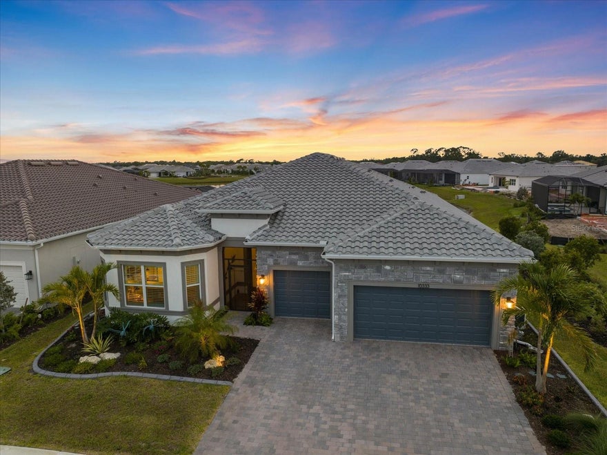 Welcome to 10333 Blue Runner Drive in the highly sought-after BEACHWALK by Manasota Key, a stunning estate home that is only a few months old and truly BETTER THAN NEW, with an extraordinary collection of luxury upgrades already completed for the next owner. Perfectly positioned to capture breathtaking WATER VIEWS and unforgettable Florida SUNSETS, this exceptional residence offers the ideal blend of sophistication, comfort, and modern convenience.

Featuring the highly desirable RENOWN floor plan with over 2,800 square feet of interior living space, this thoughtfully designed home offers 3 bedrooms, a private study/den, 3 full bathrooms, 1 half bath, and an oversized 3-car garage that is perfect for additional storage, hobbies, or a golf cart.

Inside, you’ll find TILE FLOORING THROUGHOUT the entire home, elegant TRAY CEILINGS in the great room, study, and primary suite, and high-end finishes thoughtfully selected throughout. The EXECUTIVE KITCHEN is a showstopper, featuring upgraded KITCHEN-AID appliances, DUAL WALL OVENS, a wine refrigerator, upgraded sink, QUARTZ COUNTERTOPS AND BACKSPLASH, and a spacious walk-in pantry designed for both functionality and style. Additional premium features include a KINETICO REVERSE OSMOSIS system with point-of-service at the kitchen sink and a whole-home WATER SOFTENER system. Every bathroom showcases floor-to-ceiling tile, creating a sleek spa-inspired atmosphere.

Custom organization systems by INSPIRED CLOSETS have been added to all bedrooms, the mud-room, and den, while motorized interior blinds and PLANTATION SHUTTERS provide both elegance and convenience. The home is also equipped with a SONOS sound system, and the sound, lighting, and security systems are seamlessly managed through the UXARI app for effortless smart-home living.

Step outside to your private outdoor oasis featuring a fully equipped OUTDOOR KITCHEN, high-top table and chair set (conveys with the home), motorized HURRICANE SCREENS on the lanai, fixed PRIVACY SCREENS, and beautiful exterior UPLIGHTING with landscaping CURBING that enhances the home’s curb appeal day and night.

The oversized garage is equally impressive with EPOXY flooring, a dedicated AC MINI SPLIT system, and a 4-foot GARAGE EXTENSION for additional space and comfort. A GENERAC GENERATOR adds peace of mind and ensures uninterrupted living year-round, while IMPACT WINDOWS throughout the home provide added storm protection and energy efficiency.

This is a rare opportunity to own a nearly new, extensively upgraded luxury home in one of Englewood’s premier resort-style communities, all without the wait of new construction.  Beachwalk is a gated, resort-style community offering incredible amenities designed for an active and social lifestyle, including: Resort-style pool with lap lanes, fitness center, café, tiki bar, fire pits, 10 pickleball courts, 5 tennis courts, 6 bocce courts, dog park, Community garden and so much more! NO CDD at Beachwalk! As if Beachwalk wasn't great already, exciting additions are on the horizon with a formal restaurant set to open in 2027. A third 13,000 sqft amenities building is planned to begin construction in late 2026 or early 2027. This building will feature a game room, golf simulator, an auditorium, a demo kitchen and a massive outdoor covered seating area. All of these "coming soon" amenities will further enhance the vibrant lifestyle this community already offers. All this, just 2.5 miles from Manasota Beach!