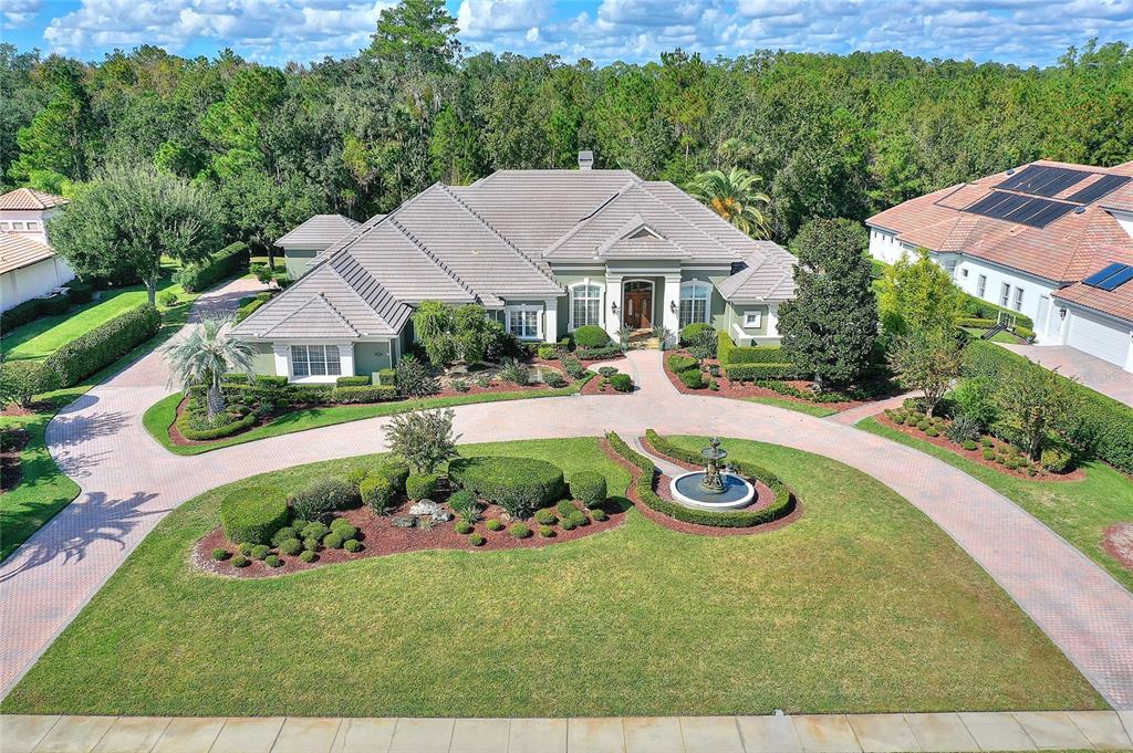 Welcome home to this Elegant and Timeless estate featuring 5 Bedroom/5 Bath/5 Car, nestled on an one-acre lush-green lot in sought-after elegant Heathrow Woods. Enter this property via an impressive brick pavered circular drive flanked by a statuary fountain with lush landscaping and a cascading tiered waterfall leading to the elegant front entry. This spacious home has nearly 6000 sf of luxuriously appointed living area and over 8600 sf under roof, including garage space for 5 cars, boat or golf cart. Among the homes many features are 3 master suites, a separate office, large theater room, a safe room, soaring ceilings, granite counters throughout, gourmet kitchen with Sub-Zero refrigerator, Wolf Induction cooktop, Wolf double oven, microwave, trash compactor, wet bar, rich wood custom built-ins and trim work throughout. A gorgeous pool and spa surrounded by a large lanai with summer kitchen backs to a gorgeous conservation view. The garage space consists of a four-car air-conditioned garage plus an additional separate oversized one car garage with oversized doors. Some of the other distinctive features include Control4 Smart Home system, Wallbox 240v car charger, EcoWater System, iDMSS Plus close circuit TV (8 zones), travertine flooring, plantation shutters, central vacuum, murphy bed, a solar heated water heater and a Generac home generator. The home sits on a magnificent lusciously landscaped 1 acre conservation lot. SEE ATTACHMENT FOR ADDITIONAL FEATURES.
Heathrow Woods is a 24-hour manned and gated community of 205 luxury homes. The residents of Heathrow Woods can take advantage of the many amenities that the neighboring Heathrow Golf Club community offers from an 18-hole champion golf course designed by Ron Garl, 13 lighted tennis courts, fitness club, spa, and fine dining. Heathrow Woods boasts a prime location for your commute to downtown Orlando, tranquil Beaches on either coast or to Orlando's famed Attractions and all points of Central Florida. Zoned for some of Seminole County's most enviable schools!
Expect to be impressed! Call us today to schedule a private tour!