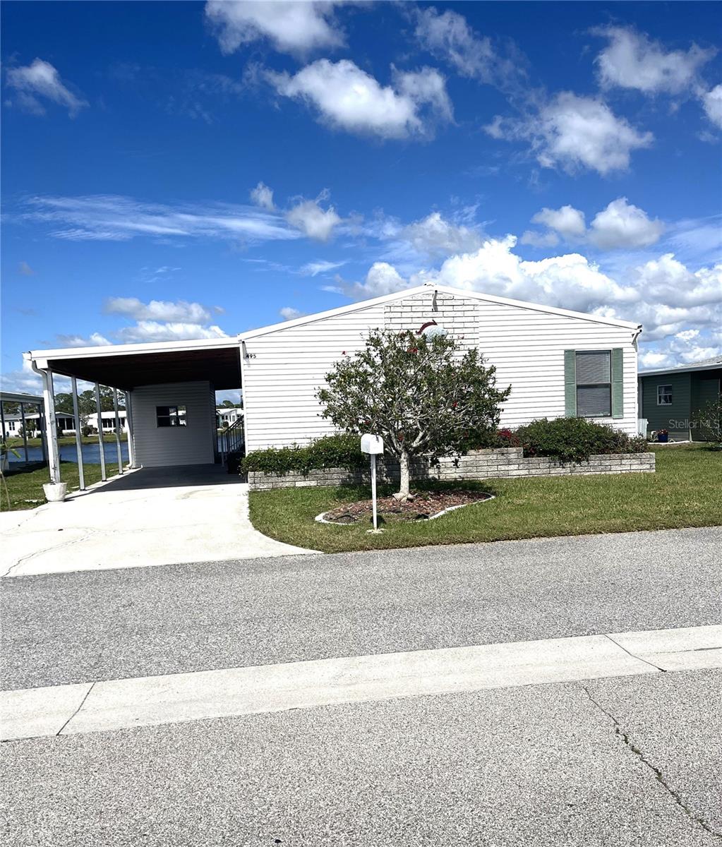 Best value for a lakefront home in the land-owned community of Harbor Isles! This turnkey 1996 home is located in the newest section of the neighborhood and offers stunning lake views, recent updates, and move-in ready convenience. With two spacious bedrooms plus a bonus room featuring built-ins, it can easily function as a 3-bedroom—perfect for guests, crafts, or a home office. The popular island kitchen opens into a bright and vaulted living space ideal for entertaining, enhanced with updated countertops, wall oven, and cooktop. Both the primary and guest suites offer ensuite bathrooms and walk-in closets for added comfort and privacy. Relax in the enclosed Florida room and enjoy morning coffee or evening sunsets while watching the lakefront wildlife. This furnished home also includes a 2023 metal roof, carport, and shed, plus a 2022 A/C—providing peace of mind and lasting value. As a resident of Harbor Isles, you’ll have access to a **private and affordable marina**, complete with boat slips, launch, canoe/kayak storage, pavilion, fishing pier, and cleaning station. Harbor Isles is a pet-friendly, 55+ community known for its resort-style amenities, modern facilities, and full calendar of activities. Just minutes from Gulf beaches, shopping, dining, Wellen Park, the Braves stadium, I-75, and more. Motivated seller—don’t miss the best lakefront value in one of Venice’s most vibrant communities!