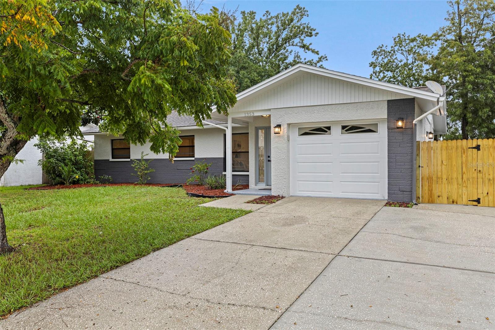 Welcome to your Dunedin retreat in the highly sought-after Piper’s Glen neighborhood! This beautifully reimagined 3-bedroom, 2-bathroom home was designed with both comfort and style in mind. Sitting high and dry in Flood Zone X, you’ll have peace of mind knowing flood insurance isn’t required. On its oversized 8,600 sq. ft. lot, there’s room to truly make this home your own—whether you dream of adding a sparkling pool, creating your backyard oasis, or simply having plenty of space for your boat, jet skis, and all the toys that make Florida living so special. The screened-in lanai is perfect for morning coffee, evening gatherings, or just soaking in the sunshine while staying cool year-round. Inside, every detail has been thoughtfully updated so you can settle right in. The kitchen is both elegant and practical with durable quartz countertops, brand-new stainless-steel appliances, and a fresh modern design. The bathrooms, flooring, and paint all reflect a clean, inviting style. With lifetime warranty luxury vinyl plank flooring, new recessed lighting, and ceiling fans in every room, this home balances beauty with everyday comfort. All that’s left is for you to relax, unwind, and start making memories in a home that’s ready for your story.