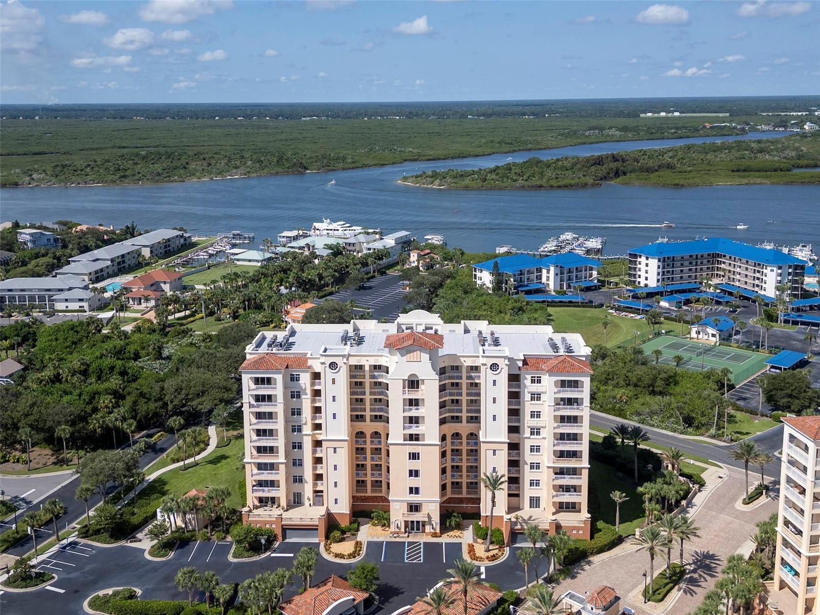 Welcome to coastal sophistication in the highly desirable Minorca community of New Smyrna Beach. This beautifully appointed 2-bedroom, 2-bath residence with a private office blends comfort, style, and functionality, offering sweeping views of the Intracoastal and beyond. Thoughtfully designed interiors feature an open-concept layout with abundant natural light, complemented by tasteful finishes and effortless flow from the kitchen to the living and dining spaces. A spacious balcony extends the living area outdoors, providing the perfect vantage point for evening breezes and breathtaking sunsets. Practical luxuries include in-unit laundry, ample storage, and an additional storage cage for beach gear, as well as assigned covered parking. For peace of mind, hurricane-rated windows and sliding doors ensure security and resilience. The lifestyle at Minorca is truly unmatched, with 24-hour guard-gated security, on-site management, and resort-caliber amenities. Residents enjoy a stunning pool and spa, state-of-the-art fitness center, clubhouse, tennis courts, BBQ grills, and a private beach pavilion. A 64-slip marina adds to the allure, offering boating, dolphin-watching, and sunset cruises, with slips available for purchase. Offering a rare balance of elegance, convenience, and world-class amenities, this residence embodies the ultimate in coastal luxury living—an opportunity not to be missed.