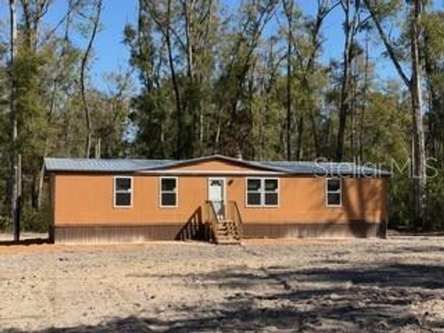 RECENTLY UPDATED 1983 DWMH on 2 ACRES! This home features upgrades such as a NEW WELL, SEPTIC, ROOF, and exterior WINDOWS! Inside, you will find new flooring, countertops, water heater, and appliances! Located on a PAVED ROAD! High and Dry! Dixie County offers low property taxes. Less than 30 miles to the Gulf of America for fishing, boating, and scalloping. Less than 5 miles to the Famous Suwannee River. Enjoy all things outdoors and nature here, including the 32-mile Nature Coast State Trail, numerous freshwater springs, and several State Parks. Call today to schedule your private tour!