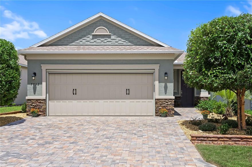Welcome to your slice of paradise in the highly sought-after Weybourne Landing, located within the award-winning 55+ community of On Top of the World in Ocala, Florida. This 2021-built modern style cottage offers the perfect blend of charm, comfort, and convenience—just a short stroll to the brand-new state-of-the-art recreation center, sparkling pool, The Circle Square Cultural Center, and The Ranch. Thoughtfully designed with over 2,000 square feet of total space, this two-bedroom, two-bathroom home boasts 1,345 square feet of interior living, an expansive 142 square foot covered lanai, a 643 square foot wraparound porch, and a 489 square foot two-car garage with epoxy floors, shelving, and a motorized screen enclosure. From the moment you arrive, you're greeted by a beautifully landscaped yard featuring paver driveway and walkways, a stacked wall, river rock accents, and a soothing fountain that sets the tone for tranquility. Inside, the home is bright and stylish with 8-foot doors, plantation shutters, and vinyl plank flooring throughoutmaking maintenance a breeze so you can focus on the active lifestyle this community is known for. The kitchen is a showstopper with quartz countertops, glass tile backsplash, stainless steel appliances, under-cabinet lighting, and even a glass china cabinet. The primary suite is a peaceful retreat, featuring a porcelain-tiled walk-in shower with bench and niche, comfort-height quartz vanity, and large walk-in closet. The second bathroom is equally stylish with tile and a glass sliding door shower. Additional highlights include tray ceilings, ceiling fans with lights in every room, laundry room with built-in cabinets, recessed lighting throughout, and a Generac whole-home generator for peace of mind. Even more perks include a pull-down attic with wood flooring for storage, a premium ecosystem water softener, and it is a "smart" home, making this home as functional as it is beautiful. Living in On Top of the World means enjoying access to multiple resort-style pools, three golf courses, fitness centers, walking and biking trails, pickleball and tennis courts, a dog park, dozens of clubs and social events, craft rooms, an on-site restaurant, and so much more. This is a golf cart-friendly, gated community designed for both relaxation and recreation. This home offers low-maintenance living in a vibrant community with everything you need at your fingertips. Schedule your private showing today and start living your best life at On Top of the World.