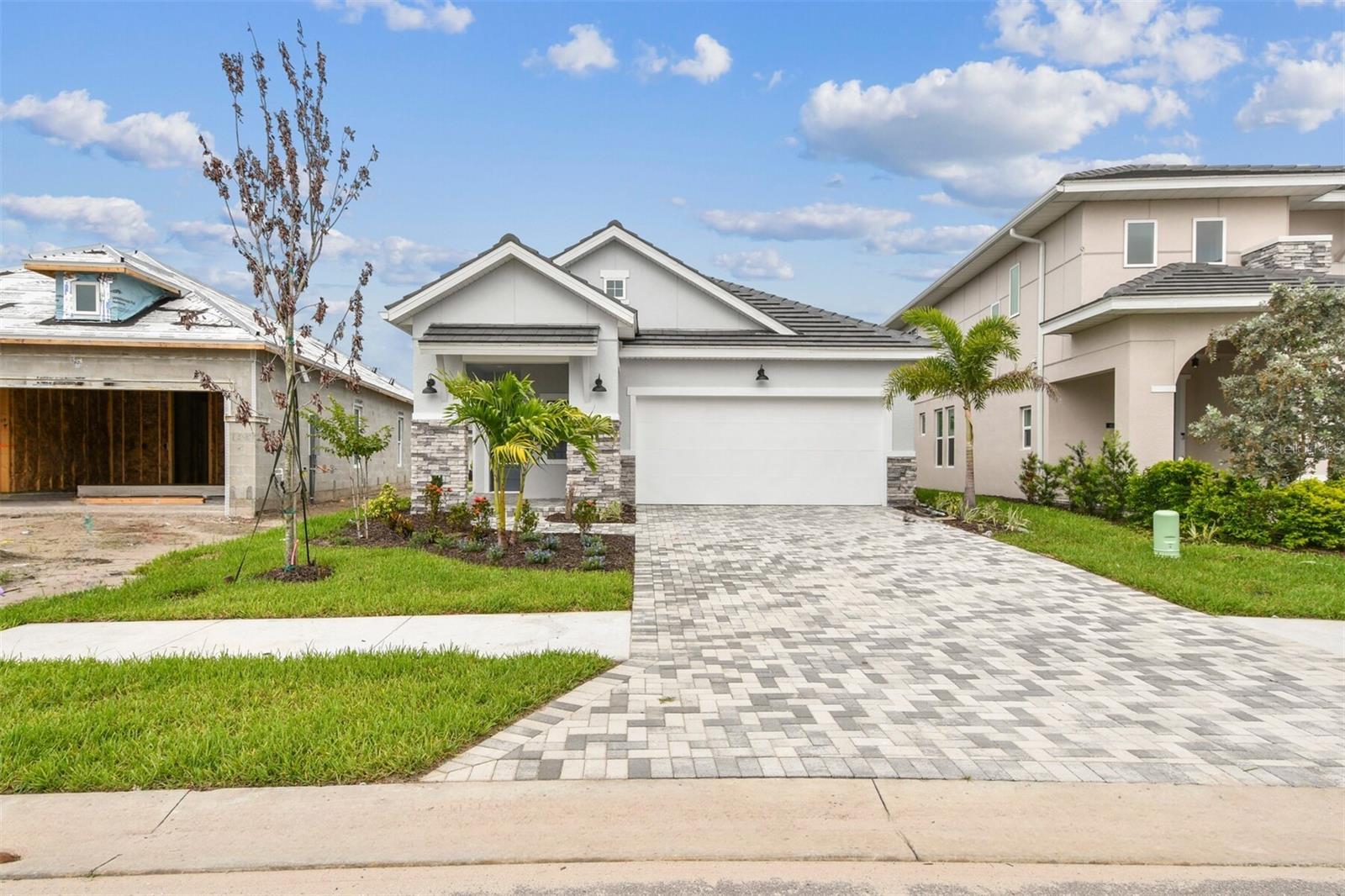 One or more photo(s) has been virtually staged. This **David Weekley Home** offers a perfect blend of comfort, style, and functionality for a dynamic lifestyle. The spacious **Owner’s Retreat** provides a serene escape, featuring a luxurious **Super Shower** and a large walk-in closet—ideal for pampering yourself after a day of active living. Whether you’re relaxing or getting ready for the day, this retreat is your personal sanctuary. The additional bedrooms are equally inviting, offering flexible spaces that you can personalize to match your lifestyle, whether for hobbies, guests, or family.
Designed for modern living, the open-concept layout includes a variety of **dining**, **home office**, and **living spaces** that are perfect for hosting friends, working from home, or simply unwinding. The **eat-in kitchen**, featuring a **Gourmet Cooktop**, will inspire culinary adventures, from preparing quick weeknight meals to experimenting with new recipes for a dinner party. With plenty of storage and counter space, this kitchen is designed for efficiency and style, making it easy to enjoy every moment spent cooking or entertaining.
Outdoor living is equally important, and the **covered porches** and **lanai** areas in both the front and back yards offer the perfect spaces to unwind after a day of outdoor activities. Whether you enjoy morning coffee in the fresh air, evening gatherings with loved ones, or simply soaking up the peaceful surroundings, these outdoor spaces support a lifestyle that values relaxation and connection with nature.
This new home offers the perfect foundation for a vibrant, active lifestyle, with modern features, thoughtful design, and ample space for both relaxation and entertaining. Plus, **David Weekley’s World-class Customer Service** ensures that your building experience will be as delightful as the home itself.