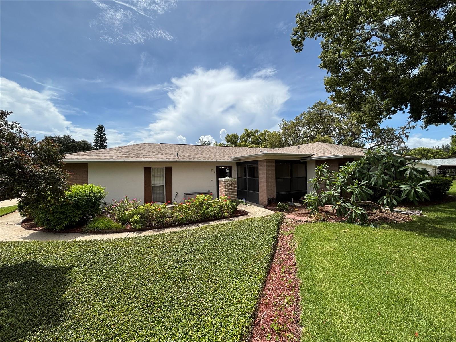 Welcome to this beautifully updated first-floor condo that offers a modern and spacious layout, complete with a one-car garage and a Florida room, all within a 55+ community. This 2-bedroom, 2-bath home features a roof that is only a year old, along with newer vinyl flooring, fresh interior paint, and new carpets in both bedrooms. Both bathrooms have also been renovated, showcasing newer vanities, toilets, and fixtures. The HOA fees include water/sewer, trash collection, expanded cable, internet, insurance, all exterior maintenance, reserves, and access to a private pool area. Fairway Villas boasts a private heated swimming pool that is linked to the Timber Oaks clubhouse, which is equipped with a fitness center and meeting rooms.