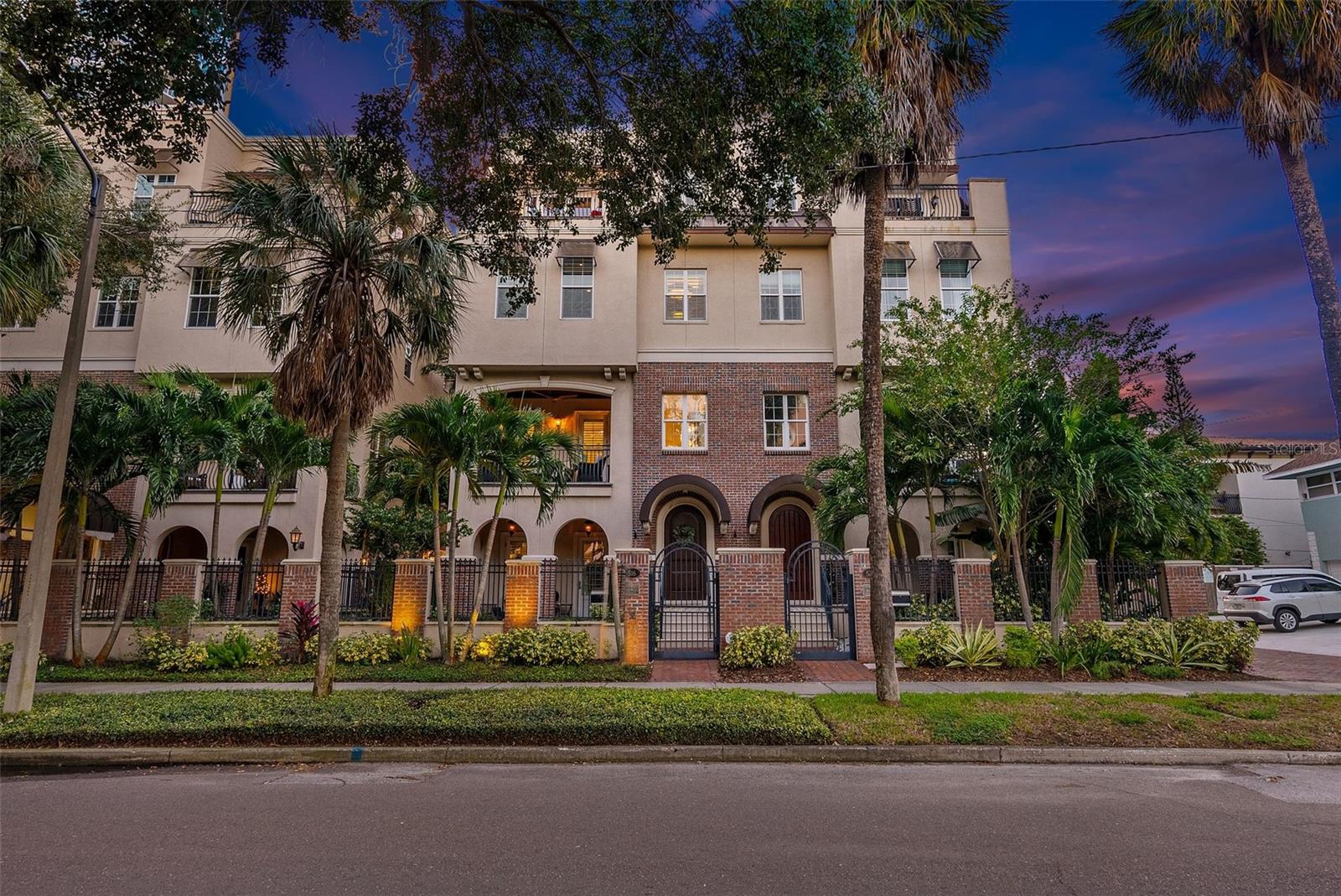 Discover the epitome of luxury living in this iconic Renaissance City Home located at 516 Beach Drive NE. This is a rare opportunity to own one of four coveted Brownstones that seldom come on the market. Become the envy of all your friends and neighbors by owning this unique, private and beautiful property that is perfect for entertaining; and best of all NO HOA! Immerse yourself in sophisticated elegance when you walk in the front iron gate off of Beach Drive and enter the private, ivy blanketed courtyard featuring a terrace, brick accents and natural gas burning lanterns. As you step in the front door, prepare to be impressed by the vaulted ceilings, quality of construction, ample natural lighting, sparkling chandelier and custom millwork. Every inch of this residence has been thoughtfully and professionally designed to perfection. The main floor features a spacious bedroom with Haiku fan, access to a large private courtyard and plantation shutters. Across the hall you will find a full bathroom and foyer that leads to a massive storage room with enough space for all of your toys and beach gear. The storage room leads directly to an oversized two car garage with hanging storage racks. Perhaps one of the biggest perks is the two car parking apron, which provides a total of 4 parking spots in downtown which is a rarity! From the main floor you have the luxury of choosing between the elegant staircase or the private elevator that services all floors. On the second floor you will find designer fixtures, a spacious formal living and dining room, and a large balcony overlooking Vinoy Park. Enjoy your morning cup of coffee and experience the daily happenings on Beach Drive from the comfort of your private balcony. Just off of the formal dining area is a spectacular, chef's dream kitchen. The kitchen is tastefully appointed with an induction cooktop, Thermador appliances, double ovens, warming drawer, and custom built in-kitchen dining space. Just beyond the kitchen is a custom built in bar with Sub Zero wine refrigerators, spacious family room with a linear natural gas fireplace and half bathroom. The third floor features three bedrooms and three full baths, including the show stopping primary bedroom, massive, must see to believe walk-in closet and custom vanity space worthy of Architectural Digest. The third floor also features the laundry room with a large washer and dryer and ample storage. The fourth and final floor is designed for fun and entertaining with a full custom bar, top of the line ice machine, sub zero wine refrigerators, a large balcony with sweeping views of Tampa Bay to watch the Regatta races or fireworks on NYE and Fourth of July, full bathroom and over 500 square foot rooftop terrace with artificial turf. Other highlights throughout the residence are the Elon entertainment system with interior and exterior speakers, Haiku fans, Generac gas whole home generator, high-end designer selected finishes, smart house capabilities, security systems and so much more! With spacious living areas, this residence seamlessly combines comfort and style, offering an unparalleled urban living experience. Perched directly on Beach Drive, this residence is within steps of fine dining, museums, miles of waterfront parks, the iconic Vinoy hotel, Albert Whitted private airport, St Petersburg Yacht club, St. Pete Pier, world class beaches and a short 25 minute drive to Tampa International Airport. Schedule a private tour today!