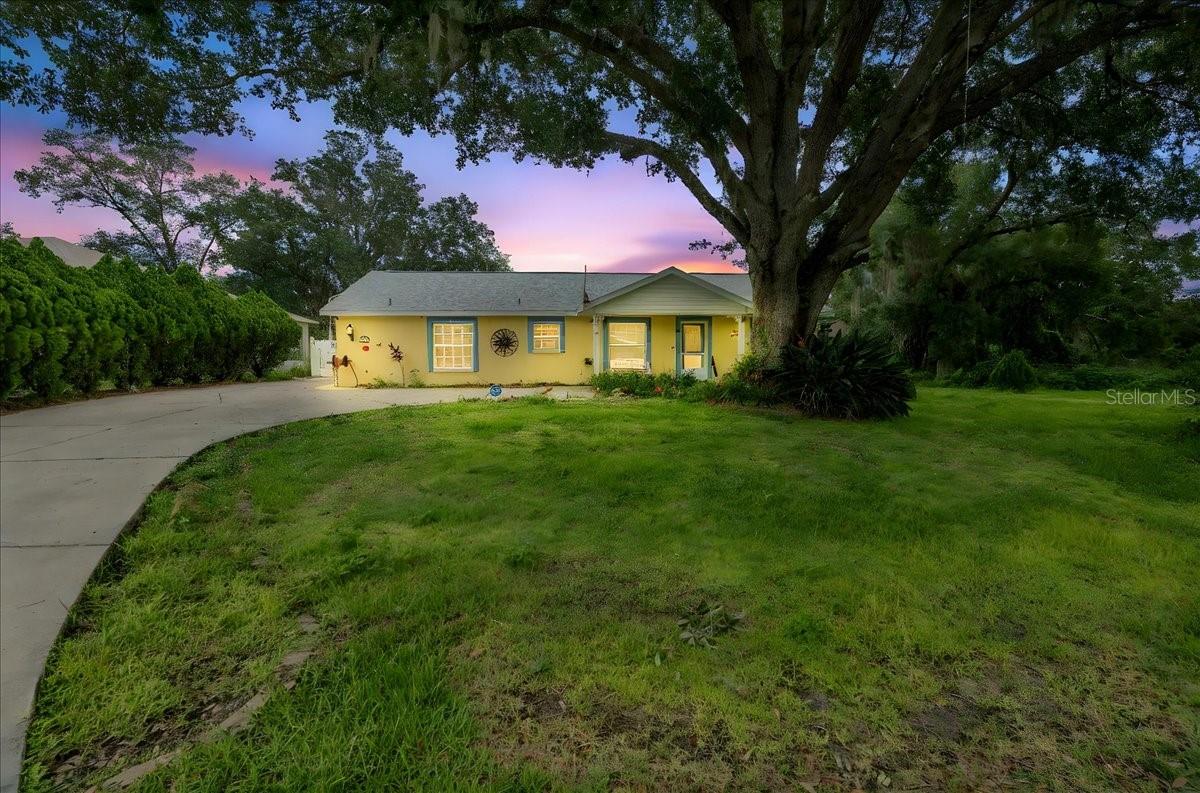 Bring the truck, boats, RVs, and all the toys—there’s room for everything here! Welcome to this meticulously maintained custom-built home located on a quiet dead-end street in desirable San Antonio, Florida—free from HOA restrictions and costly CDD fees. This thoughtfully designed residence features a split floorplan with remodeled walk-in showers and dual walk-in closets, ideal for comfortable everyday living. The open-concept layout boasts new luxury vinyl plank flooring, recessed lighting, ceiling fans, and pocket doors throughout. The spacious kitchen offers abundant counter space and storage, flowing seamlessly into a utility room equipped with washer/dryer hookups, extra space for refrigerator/freezer, and additional cabinetry. French doors lead to a recently screened 16x10 tiled patio with a ceiling fan, creating a seamless indoor-outdoor living experience. The fully fenced backyard includes a high-strength concrete pad with covered parking and 50 AMP service—perfect for your RV, boat, or vehicles—plus two utility sheds and a separate workshop. Pets will love the spacious, fully fenced yard—perfect for playing, exploring, and enjoying the outdoors safely. Additional upgrades include a whole-home Generac generator, water softener, a 250-gallon propane tank, and an air compressor. A new roof was installed in 2023 and the HVAC system was replaced just three years ago. Located only minutes from Mirada and Epperson Lagoons and within 15 minutes of daily necessities, this home blends peace, practicality, and convenience in one exceptional package.
