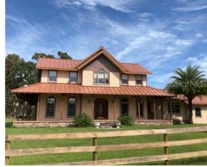 Nestled among prestigious multi-million-dollar horse estates, this enchanting, one-of-a kind home radiates charm and character, far beyond the typical Florida design. Set majestically at the end of a long, private paved driveway, this custom four-bedroom, four-and-half-bath estate rests on a breathtaking 10-acre flag lot adorned with "grandfather" oak trees and beautiful tranquil evenings. The expansive interiors features a grand home office, study, formal living and dining rooms, a cozy wood-burning fireplace, and a gourmet kitchen with bespoke range. Rich hardwood floors, soaring ten-foot ceilings and seven-foot windows bathe the home in natural light. The master suite is a sanctuary, boasting a serene sitting area graced by imported stained-glass windows from Paris. Outside, the property is a haven for equestrian dreams- a five-stall center-aisle barn, complete with feed and tack rooms, a workshop area, three paddocks, four turnouts and plenty of usable acreage for additional cross fencing and expansion. With the pristine, registered Carter Pond as the homes backdrop this is one of the few waterfront properties in the Ocala area that does not require flood insurance. This rare gem located in premier horse-country is just minutes from both WEC and HITS. A motivated seller awaits- don't miss your chance!