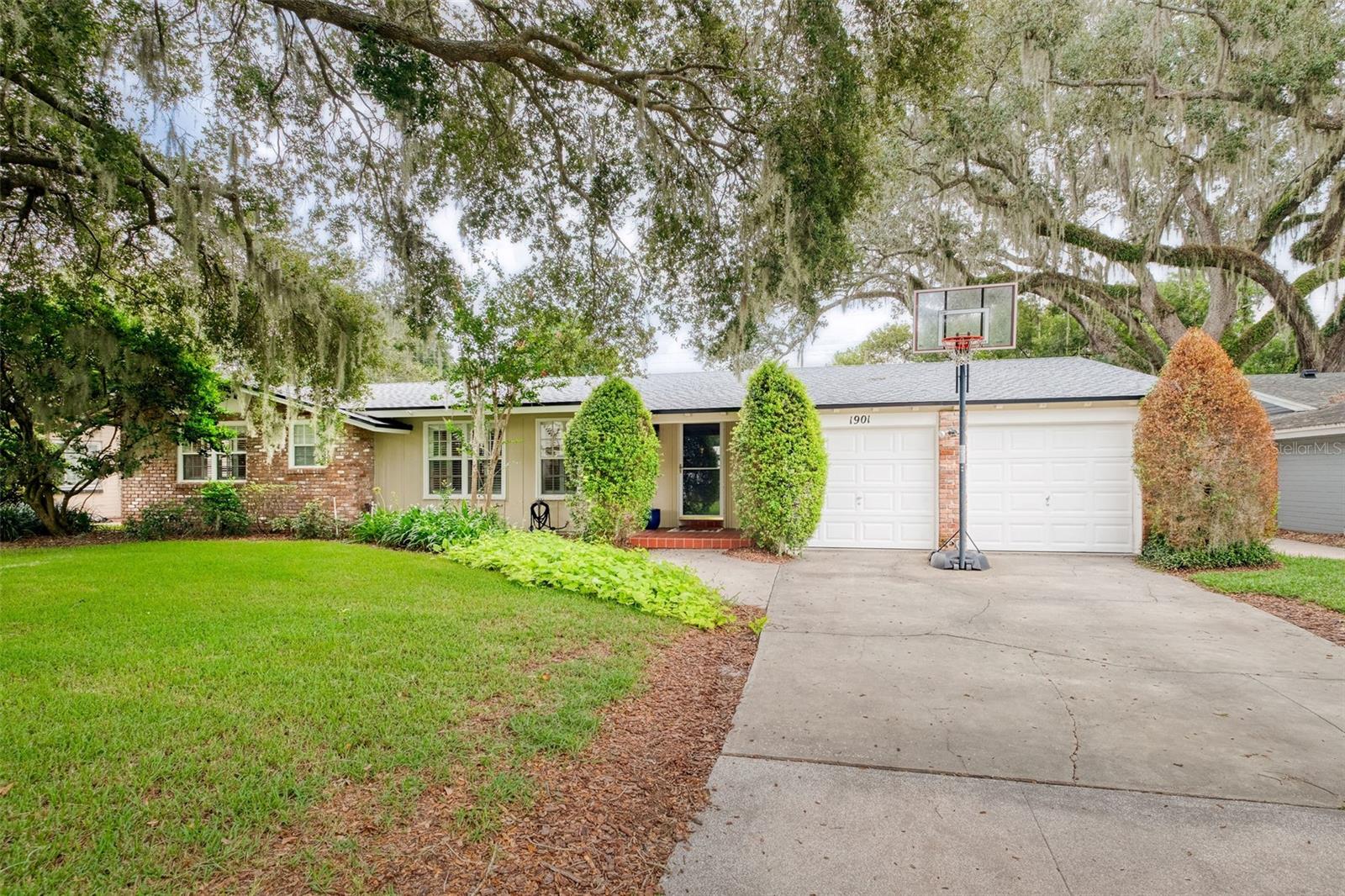 Here is the combination of charm and location you have been looking for in a home! This 3 bedroom, 2 bath, pool home is located in the highly sought-after Audubon Park Garden District, zoned for Audubon K-8 and Winter Park High School. Surrounded by mature oak trees, you'll love living just steps away from Leu Gardens! Enter the home into the gorgeous living room, noticing the light hardwood floors, plantation shutters, crown molding, and lighted built-in shelving with cabinets. Adjacent to the living room and just off of the kitchen, space to enjoy your meals in the cozy dining room, overlooking the backyard and pool. Off of both the living/dining area, to one side, is a large bonus room, which has enchanting, vaulted ceilings, a built-in desk with cabinets, a wall of windows to let that Florida sunshine in, as well as additional storage. You will also be able to access both the pool and the garage from this room. The kitchen overlooks the sparkling pool and large fenced in backyard, where you're sure to enjoy playing, swimming, grilling, and entertaining. The kitchen has newly painted cabinets and fixtures, beautiful granite counter tops, and all new stainless-steel appliances. Down the hall you will find the primary bedroom with an en suite bathroom, two closets, and access to the pool through another French door. All bedrooms have beautiful hardwood floors, plantation shutters, and ceiling fans. The roof is only 3 years old, and HVAC is 5 years old. The location of this house can’t be beat with just less than 2 miles to Publix, Baldwin Park, The Milk District, dining, and local shopping! Less than 4 miles is downtown Orlando! Also close by is Rollins College, Park Avenue, and the quaint cities of Winter Park and Maitland! And if you’re traveling for work or pleasure, the Orlando International Airport is only 30 minutes away! Come see this adorable home today!