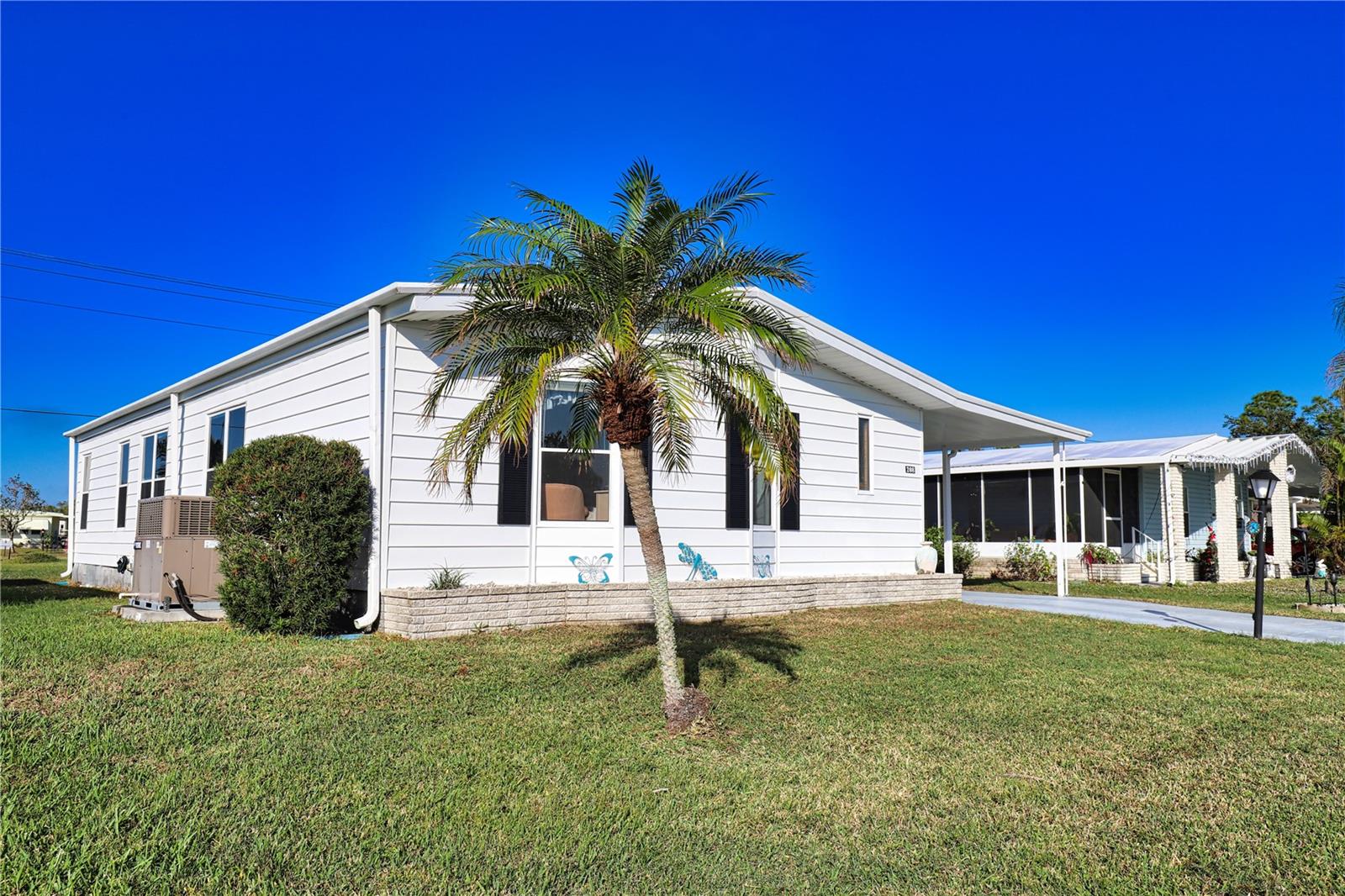 Don’t miss your chance to own a piece of paradise! This must-see home has a unique split bedroom floorplan. The large living opens to the dining room / kitchen combination which makes it the perfect home for entertain guests. Off the dining room is the Florida Room which is ideal for additional entertaining, or enjoying your beverage of choice on those cooler evenings. Both the primary bedroom with an ensuite bathroom and the guest bedroom are extremely roomy and provide their occupants with lots of privacy. Another distinctive characteristic to this home is the generously sized laundry room with a window for natural light. This home will make all of your Florida dreams come true and it’s located in the pet area so your furry friend will be able to enjoy paradise with you!
La Casa boasts 974 homes nestled among a variety of native trees with spacious common grounds surrounding our eight lakes. Our lots average a generous 60' by 80'. The ultimate lifestyle on Florida’s Gulf Coast is located between Sarasota and Fort Myers and is a boater's dream with access to the Gulf of Mexico. It is convenient for shopping, sightseeing, golfing, fishing, and boating, as well as all the culture and elegance the Southwest Florida area is noted for. Residents and visitors enjoy the warmth of Southwest Florida winters in a relaxed and unhurried environment far removed from the hustle of Florida’s east coast. You’ll be surrounded by mature lush landscaping which demonstrates the utmost level of care our property receives from residents and management. La Casa may have the best pools in the area. Our crown jewel is an extremely large, 40 X 60-foot swimming pool that is kept at a perfect 87 degrees. Our smaller 20 x 40 pool is quietly nestled between the clubhouse and the Activity Building. Both pools have adjacent hot tubs which are ideal for soaking muscles that are tired from golfing or tennis. Wireless Internet (Wi-Fi) is available at the Clubhouse, Activity Building, and Recreation Hall area where these pools & spas are located, so you can catch some rays while you catch up on your email! Sound enticing? La Casa is a friendly, family community. You will be away from the hustle and bustle except when you want to be part of it. Come for a visit to this self-contained oasis and see for yourself why La Casa is the ultimate destination for both snowbirds and year-round residents!