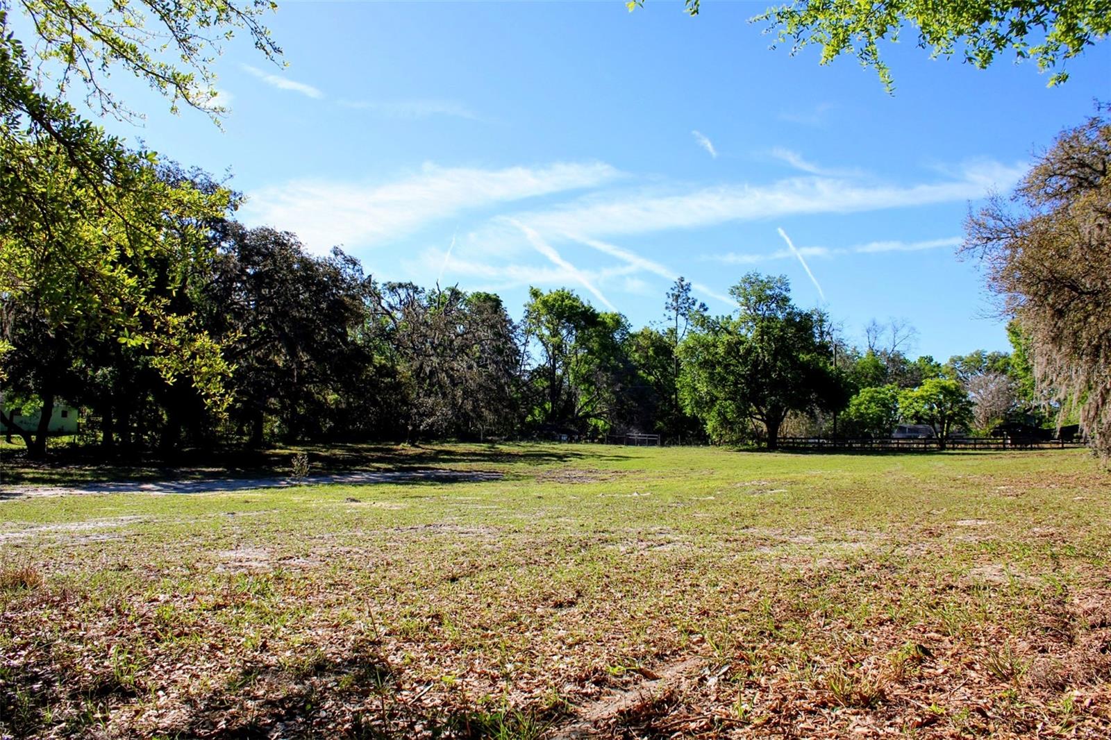 Prime location! 2.4 acres nestled in the heart of the rolling hills in Dade City await your future dream home! This property is high and dry and allows plenty of room for animals, a barn, pool, or a family compound! The property features mature oak trees along the perimeter of the property providing maximum privacy but the property has been completely cleared down the middle, ready for your future home to be built! A brand new driveway/culvert has been installed, creating easy access directly from St. Joe Rd. but also features a secondary gated entrance at the back of the property. Almost fully fenced in, just needs a a front entrance gate!
The property can be divided into 2 parcels, and allows for one single family home to be built per acre!
Approximately 5 minutes to Historic downtown Dade City where you can indulge in the small town charm with local culinary delights, breweries, shopping, parks, bike trails, drive in movies, festivals, Snowcat Ridge, and the new splash pad! Situated right near Happy Hill Rd. which provides easy access to I-75 only 5 miles away! Approximately 20 minutes from Wesley Chapel where there is an abundance of shopping at 2 malls, endless dining options, hospitals, and the largest ice skating rink in the Southeast! Plenty of fun activities to do whether you immerse yourself locally in the small town living or drive a little further for larger amenities, you will remain tucked away in your own private country living.
Schedule a showing to view this gem today!