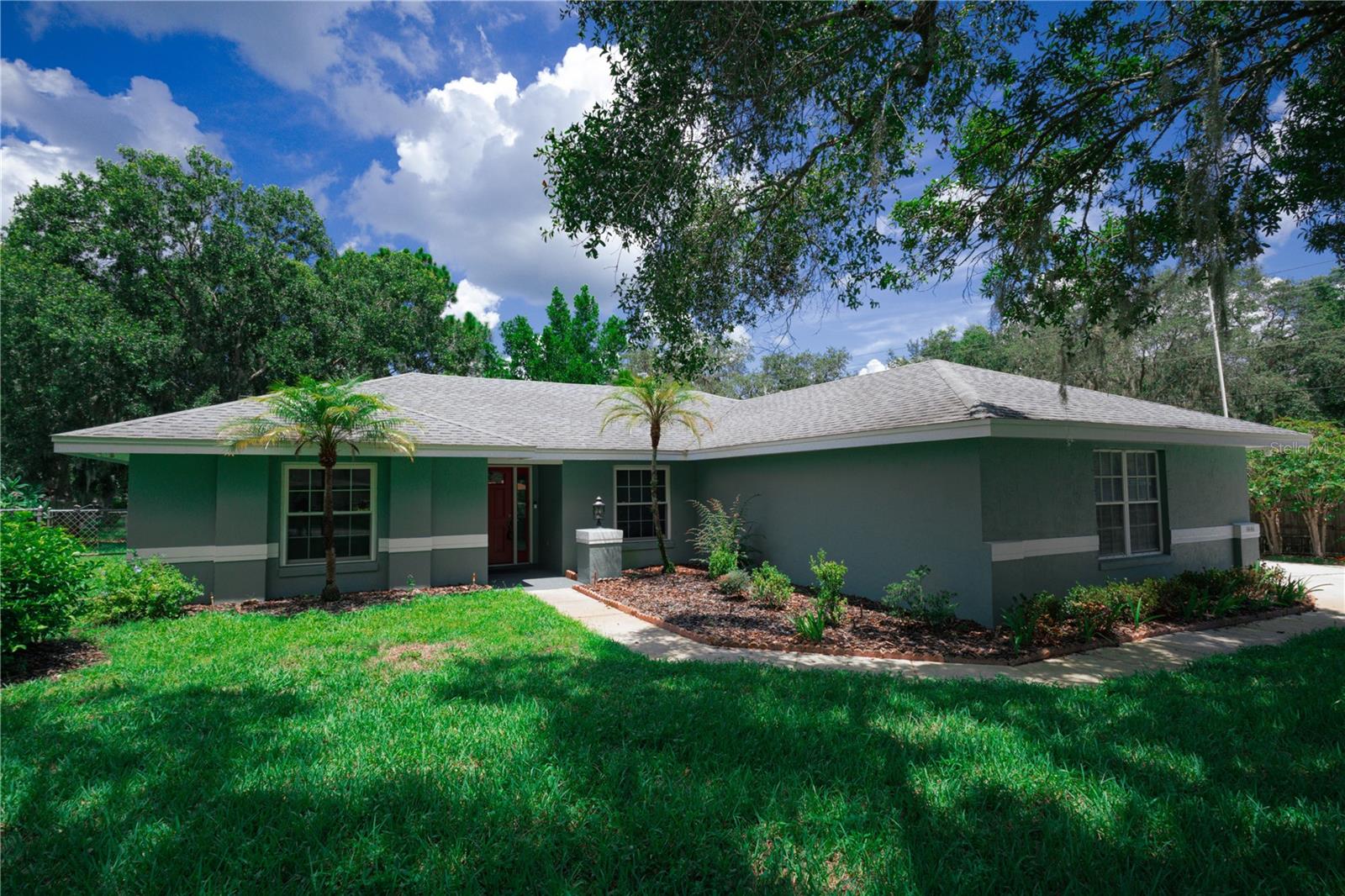 3 BR, 2 bath with split open floor plan on corner lot with oak trees for shade in front and rear and 1 lemon tree. Most all interior walls are freshly painted. Vaulted ceiling in living area. Remodeled kitchen with granite counters, stainless appliances, and 2 pantries. Remodeled shower and floors in Master bath. Two vanities in Master bath. Walk in closet for Master Bedroom. 12 x 16 screened room with like new sliding glass doors. Fenced back yard. Irrigated yard with new timer using well water and county water for the home. 2 car garage with side entrance.