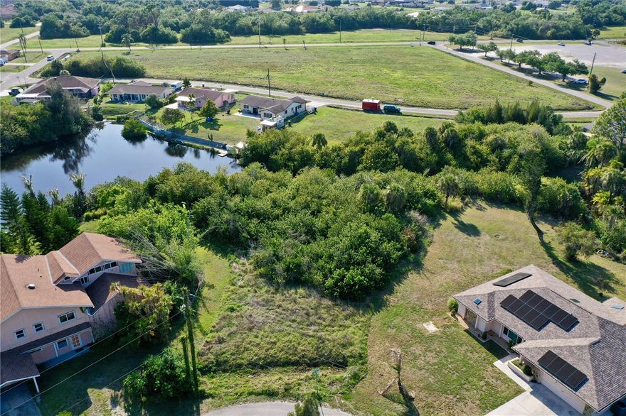 Embrace the legendary lifestyle of Warm Mineral Springs with this exceptional .24-acre residential lot, perfectly situated on a corner at Monza Avenue. This prime 10,466-square-foot property offers 56 feet of road frontage and an impressive 140+ feet of canal frontage along the rear, providing a serene water view and extra privacy for your future home. Building here is simplified as the lot is NOT located in a scrub jay review zone according to the North Port GIS map, and it is ready for your custom well and septic system. The location is truly unbeatable for wellness enthusiasts—you are just around the corner from the world-famous Warm Mineral Springs Park. Known as the "Fountain of Youth," these 85-degree year-round waters contain over 50 essential minerals, offering therapeutic benefits for circulation, joint pain, and skin health that draw visitors from across the globe. Beyond the springs, this property serves as a gateway to the best of Southwest Florida. You are just a short drive from the convenient shopping and dining corridor of US-41, and only about 15 minutes from I-75, providing effortless access for north and south travel throughout the state. For those who crave the sand and coastal waters, the pristine Gulf beaches of Englewood and the exclusive shores of Boca Grande are approximately 25 minutes away. Avid golfers will find themselves in paradise with a multitude of premier courses nearby, including those in Wellen Park and North Port, ensuring a new challenge is always just minutes from your front door. Whether you are looking to build a seasonal retreat or a permanent sanctuary, this oversized canal-front lot offers the perfect blend of natural healing, outdoor recreation, and Florida sunshine.