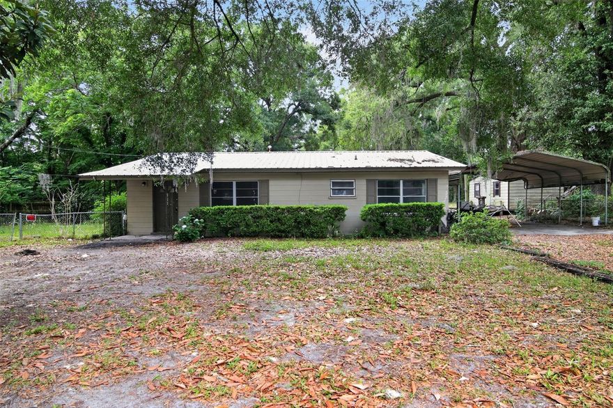 Opportunity awaits in the heart of Newberry! This 3-bedroom, 1-bathroom, 1,148 square ft home sits on a spacious 0.29-acre lot, making it an excellent option for investors, first-time buyers, or anyone looking for a property with renovation potential and classic Florida charm.

Surrounded by mature trees and shaded by beautiful oak canopies, the property offers a peaceful setting with plenty of outdoor space for gardening, entertaining, or future improvements. The covered carport and extended driveway provide ample parking and functionality.

Inside, the home features a large kitchen with original wood cabinetry, generous cabinet storage, and an open layout ready for your personal updates and design vision. Natural light fills the living areas, while the split layout provides flexibility for everyday living. With solid bones and vintage character throughout, this property is the perfect canvas to create your dream home or next investment project.

Conveniently located near local schools, shopping, dining, and just a short drive to Gainesville, this property combines small-town living with easy access to nearby amenities.Whether you’re looking to renovate, invest, or make it your own, this Newberry property is full of potential and priced to inspire opportunity.