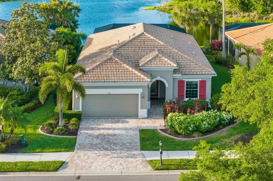 Discover a rare lifestyle opportunity in Bradenton’s premier golf and marina community. This former model home at Waterlefe Golf & River Club is situated on a unique "double bonus" lot, offering panoramic views of both the water and the challenging par-5 sixth hole. Premium Upgrades & Modern Infrastructure were Designed for peace of mind and efficiency as this residence features full impact-rated windows and pocket sliders. Inside, the high-end updates continue with a gourmet kitchen boasting Zodiac quartz countertops and custom wood cabinetry, complemented by elegant crown molding and tray ceilings. The home is illuminated by newly installed, energy-efficient LED recessed lighting to modernize many spaces. Mechanical upgrades include a tankless gas water heater, a water softener, and a dedicated pool heat pump. Elite Outdoor Living is the true highlight here as it epitomizes the outdoor lifestyle. Step through impact-glass pocket sliders to a newly screened lanai—recently re-secured and powder-coated—which serves as your front-row seat to "The View" you've been wanting. The outdoor lanai features a newly resurfaced pool and a freshly sealed paver deck, providing the perfect open space for entertaining. The refined Interior Comfort is highlighted by the primary suite which includes a custom-designed closet and a contemporary bathroom featuring a frameless glass shower enclosure and designer tile work. For ultimate flexibility, the den and second bedroom feature built-in Murphy beds, providing both style and convenience for you and guests. Come check this place out - you won't want to leave.  More than just a neighborhood, Waterlefe offers residents access to an array of amenities centered around the Waterlefe River Club. Recently updated, the community owned clubhouse features a restaurant, bar, fitness center, meeting space, tiki bar, and a Jr. Olympic pool—truly the heartbeat of the community! Imagine filling your social calendar with daily fitness classes, card games, social functions, and book clubs. Waterlefe is also very pet-friendly, so bring your furry friends along! While golf club memberships and marina slips are available, they are entirely optional. The new Golf Clubhouse and Sunset Grille are receiving rave reviews from residents and guests alike. For added convenience, high-speed Wi-Fi, cable TV, and internet as well as a full service exterior maintenance package are all included in the HOA fees. Come see this view in person and you’ll understand why this should be your new home. (Note: CDD is included in the total tax amount.) Check out the Matterport as well on Virtual Tour #2