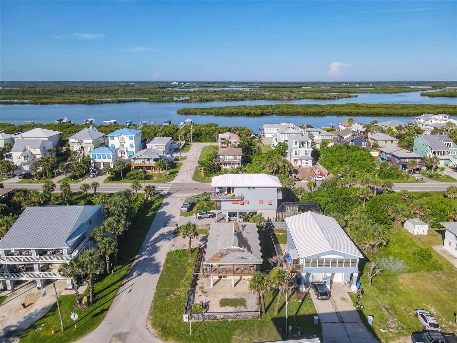 Peaceful retreat with ocean views located directly across from the secluded Bethune Beach, the non-driving section of New Smyrna Beach. Ideal opportunity for anyone looking for a beach property to renovate into the home of your dreams or as a vacation rental property with great earning potential. Vacation rental income numbers can be provided to qualified prospective buyers. Perfectly situated in between the Atlantic Intracoastal Waterway and the Atlantic Ocean (private dunes walk-over), moments from Flagler Ave and Canal St, Canaveral National Seashore, major highways and more.