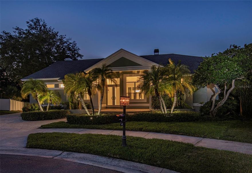 One or more photo(s) has been virtually staged. Tucked away on a private cul-de-sac within the highly sought-after waterfront community of Philippe Pointe in Safety Harbor, this estate seamlessly blends timeless elegance with modern functionality. Situated on an expansive, secluded homesite, this 4-bedroom + office, 3.5-bath residence with a 3-car garage offers refined living at its finest. Walk up the circular paver steps to a grand double-swing front entry that welcomes you into an impressive interior defined by soaring 12-foot ceilings, stately 8-foot solid-wood doors, and a sleek, cohesive design throughout. The heart of the home is a chef-inspired kitchen featuring an oversized center island that effortlessly opens to the family room, where a fireplace creates a warm yet refined focal point—perfect for both everyday living and upscale entertaining. Thoughtfully designed with solid wood cabinetry, stone countertops, dual walk-in pantries, and a built-in desk area, the kitchen balances beauty and utility. The intelligently designed three-way split floor plan provides exceptional privacy and flexibility, ideal for multigenerational living or guest accommodations. The luxurious primary suite is a true retreat, complete with its own fireplace, dual walk-in closets, and a spa-like ensuite featuring separate his-and-hers vanities, a walk-in shower, freestanding soaking tub, and a private water closet. An adjacent private office offers the ultimate work-from-home sanctuary. Additional highlights include an interior laundry room with utility sink, recent upgrades include KitchenAid refrigerator and dishwasher, new carpet, fresh interior paint, new sod, and a fully updated irrigation system. Major systems have been thoughtfully addressed with a 2023 roof, dual HVAC units (2023 & 2017), and recent servicing for peace of mind. The spacious 3-car garage is enhanced with a convenient storage loft with pull-down stair access, offering ample room for organization without sacrificing parking space. This exceptional property delivers privacy and functionality in one of Safety Harbor’s most desirable enclaves—just moments to Philippe Park and charming downtown with top-rated amenities.