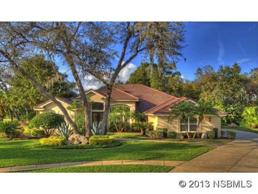 BEAUTIFUL HOME ON EXTRAORDINARY LOT, in prestigious Spruce Creek Fly-In. Located in a private, park-like setting on over  acre offering stunning landscaping, the property is bordered by a pond & conservation area. This elegant 4BR, 3.5BA residence has a tile roof & oversized, side-entry 3-car garage. Upon entering, the open floor plan offers exquisite formal areas & welcoming informal areas. The Family Room is expanded, with generous window, French doors & a gas fireplace. The spacious Kitchen offers granite counters, breakfast bar, planning center, walk-in pantry & a caf area overlooking the pool & yard. A spectacular Master Suite with double doors boasts a master bath with walk-in shower, soaking tub, dual vanities & a generous walk-in closet. This unique floor plan offers 2 expanded bedrooms & 2nd bathroom w/ walk-in shower, tub & double vanity. The 4th bedroom & bath are positioned perfectly to serve as a guest area or office. The screened lanai extends from a deep covered patio, offering a 36 heated pool & spa plus separate pool bath, perfect for the Florida lifestyle. This impeccable home features high ceilings, architectural details, crown molding, zoned HVAC, security system, intercom & large laundry room with a tub. Spruce Creek Fly-In, located close to shopping, restaurants, schools, interstate highways & recreation areas, is a staffed, gated community with country club membership options, an on-site caf and a private 4,000' runway. ;Water: City