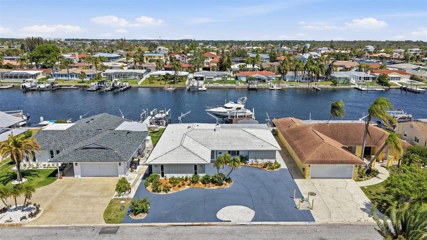 One or more photo(s) has been virtually staged. SELLER FINANCING AVAILABLE AT 4% OR LESS! Welcome to your waterfront dream in Flor a Mar, part of Gulf Harbors in New Port Richey, set on the WIDEST DEEP WATER canal with NO BRIDGES and quick access to open water, ideal for a sailboat or yacht. This fully renovated 3 bedroom, 2 bath home has been thoughtfully updated from top to bottom with wood look tile flooring, quartz countertops, an expansive buffet, and new stainless steel appliances. The living room centers around a cozy wood burning fireplace, while the expansive sunroom, lined with windows, fills the space with natural light and offers the perfect place to unwind, taking in peaceful water views, spectacular sunsets, and the occasional dolphin or manatee passing by. Major updates include a 2021 AC and water heater, a 2012 barrel tile roof, 2025 flat roof, and all new IMPACT WINDOWS, offering lasting peace of mind for years to come. Step outside to enjoy your morning coffee under the gazebo, then head down to your newly refurbished marine lumber dock, complete with a 25,000 lb lift and two davits for jet skis or kayaks, everything you need for effortless days on the water. Here, every day feels like a vacation. In this golf cart friendly community, residents have the option to join the Gulf Harbors Beach Club, a private shoreline oasis with cabanas, grills, and unforgettable sunsets, along with the Civic Association, offering access to two boat launches, social clubs, and a vibrant calendar of community events. Conveniently located near dining, entertainment, parks, and shopping, with Tampa International Airport about 45 minutes away and Florida’s beautiful white sand beaches just a short drive. No mandatory HOA, short term rentals OK! Secure this amazing opportunity today before someone else does!