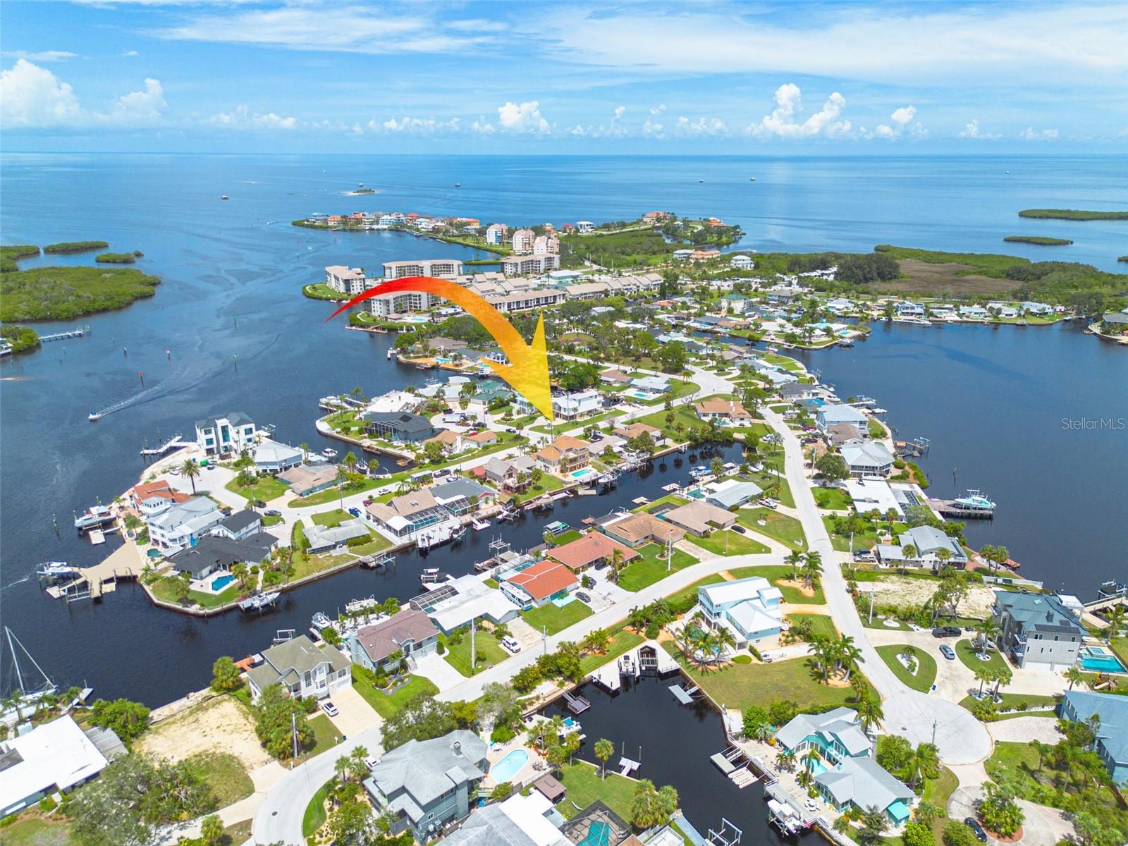 Discover the ultimate Florida lifestyle in this stunning 3-story waterfront home, perfectly designed for comfort, versatility, and entertaining. Situated on over a ¼-acre lot in a highly sought-after golf cart community just minutes from restaurants and shopping, this residence offers 5 spacious bedrooms, 3.5 bathrooms, and breathtaking views throughout. Multiple porches and balconies provide the perfect vantage points to take in the water and enjoy coastal breezes. The third-floor master suite features a large private porch overlooking the water and pool, offering gorgeous, serene views. The versatile downstairs level, complete with its own kitchen, laundry, and private entrance, is ideal for a rental, guest suite, or mother-in-law quarters. The gourmet kitchen boasts granite countertops, a double oven, wine cooler, and a bright eat-in area, while soaring high ceilings—including a dramatic cathedral ceiling—enhance the open, airy feel throughout. Enjoy the outdoors with two boat lifts (14,000 lb and 10,000 lb), a sparkling pool with a brand-new 2025 pool pump and 2024 pool filter, and a spacious U-shaped driveway leading to a 2-car garage plus a tandem garage. Recent updates include brand-new window glass being installed in September 2025, a 2023 roof, and two new 2023 AC units. Additional features include a central vacuum system and an inviting neighborhood perfect for golf cart rides to local dining. INSIDE DOWNSTAIRS IS INSURABLE! This is coastal living at its finest!