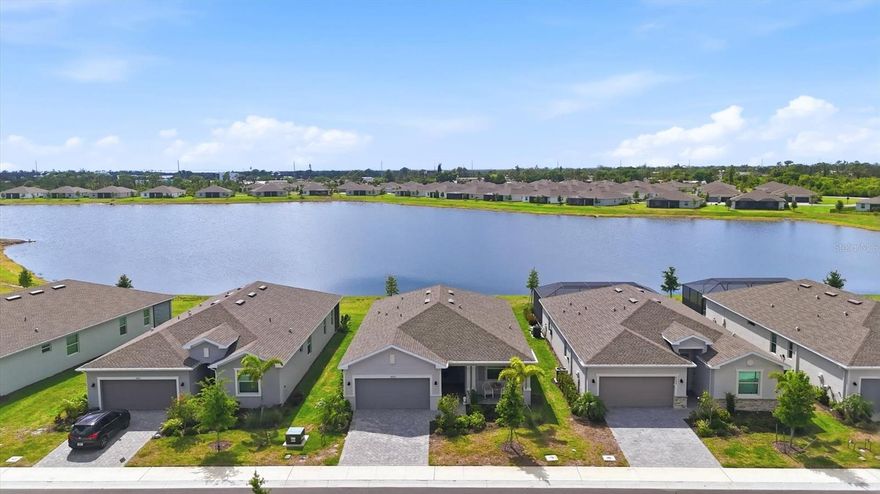 WHY WAIT for new construction when you can have this nearly brand-new, move-in ready home today!? Welcome to 8692 Coco Bay Blvd in the desirable Island Lakes at Coco Bay, featuring the popular Venice II model and offering a premium WATERFRONT setting with Western Exposure—perfect for enjoying breathtaking Florida sunsets from your own backyard! Ideally located within the community, this home is just a short and easy walk to all of the the RESORT-LIKE AMENITIES and mailroom, while still providing a peaceful and private outdoor space with serene POND VIEWS.

Inside, you’ll find a light, bright, and open split-bedroom floor plan designed for both comfort and functionality. The home features stunning tile flooring throughout, Impact-Rated Sliding Glass Doors and Windows, and beautiful finishes at every turn. The spacious kitchen is equipped with stainless steel appliances, pantry, ample cabinetry, and a large center island with bar-stool seating—perfect for everyday living and entertaining. The interior flows seamlessly to the covered, screened lanai, where you can relax with your morning coffee or unwind in the evening while taking in the tranquil surroundings.

Additional features include a dedicated laundry room with washer and dryer included, window blinds, rain gutters, sidewalk access, and lush, well-maintained landscaping. Golf carts are allowed, adding to the convenience and lifestyle this community offers. Island Lakes at Coco Bay is a gated, monitored community with an onsite manager and resort-style amenities, including a community pool, screened clubhouse area, pickleball courts, fitness center, playground, as well as lawn care and basic cable included.

This home is ideally situated close to local restaurants, grocery stores, shopping, schools, and golf courses, and just a short drive to the stunning beaches of Manasota Key and Boca Grande. Offering the perfect combination of location, lifestyle, and value, this is a must-see property. Call today to schedule your private showing!