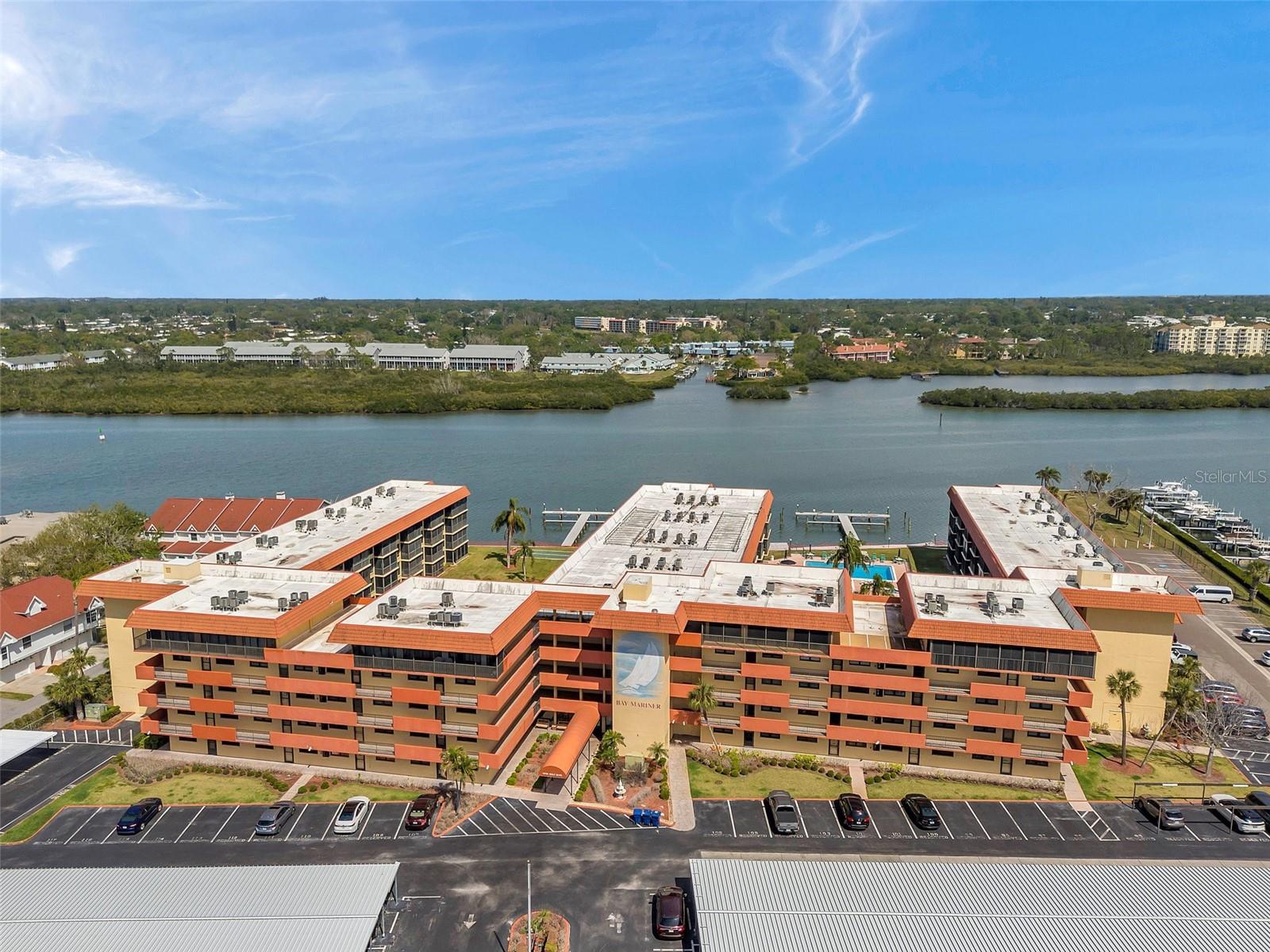Your Beach home awaits! This 2BR/2BA Bay Mariner Turnkey unit on Beautiful Indian Shores is an amazing opportunity to live just a few steps to the beach. Walk into the front door and you can immediately see the out to the intercoastal. There’s a dining area, leading into the kitchen with easy access to your living room with a nice view out to the water. The layout gives you nice separation between bedrooms, both with connecting baths. This quiet location puts you just steps away from a beach access as well as bay access and a large dock to fish, paddleboard, etc. The super-clean condo has been update in all the right places. You’ll find light wood-look Vinyl planks throughout all the living areas and bedrooms. The windows, slider, A/C and on-demand hot water heater are all newer. The patio was recently renovated, with new screen enclosure with adjustable shades screens to let in the light and still have a nice breeze through the space. The condo complex has a TON of amenities to include a heated pool, spa, saunas, workout rooms, clubhouse, shuffleboard, 400' of waterfront and docks with first come-first serve boat tie ups, bike racks and game room. Your monthly fee include access to all these amenities along with water, sewer and trash service. The unit comes with a storage room and an assigned parking space. HVAC was updated in 2022. Monthly rentals permitted. Pets are welcome. The location couldn't be better. Walk across the parking lot to restaurants, shops and more! Best of all, the unit is being sold with all furniture and household items included! Easy to show! Units at this pricepoint are a rare find!
