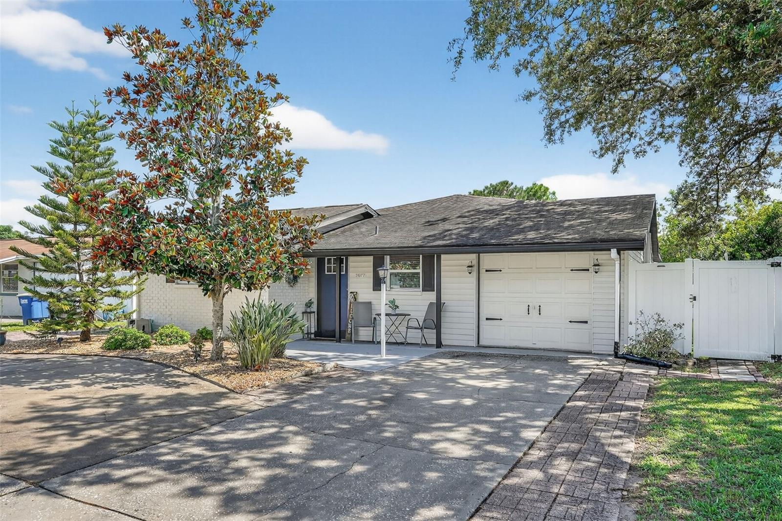 Every detail of this 2,168 sq ft home showcases sophisticated design and luxury finishes, creating a move-in ready retreat with style and charm. Featuring 3 bedrooms + office and 2 bathrooms, you’re sure to fall in love. Without an HOA, you have the freedom to do what you want with your land.
The large U-shaped driveway has plenty of space for multiple vehicles, plus boat and RV parking. Outside, the backyard is a true showpiece: fully fenced with lush, perfect grass. Enjoy a screen-enclosed lanai (added in 2023), a commercial-grade gazebo with lights and fan (outdoor dining set included), and two sturdy storage sheds. You’ll also be wowed by the finished, separate studio space — perfect for a lucrative home business, gym, or creative retreat. This finished bonus area adds versatility and long-term value.
Inside, you’ll find high-end tile and luxury vinyl flooring, granite countertops in the kitchen and baths, stainless steel appliances with an upscale range hood, a separate dining room, and barstool seating at the kitchen counter.
The living room impresses with its size and style, an expansive space where custom millwork adds character to the walls and a striking wood-burning fireplace serves as a warm, focal point.
The primary suite offers French doors to the private screened porch, along with an en-suite bath featuring a double vanity, designer tile, and a rainfall shower with separate wand. The split floor plan places two bedrooms and a second bath on the opposite side for privacy. An additional custom office with built-in cabinetry makes working from home a breeze.
The location is unbeatable. Walk to Cliff Stephens Park with trails, boat launch, disc golf, pickleball courts, and playgrounds or discover nature at the nearby Moccasin Lake Nature Preserve. Commuting is convenient with quick access to McMullen Booth, US-19, the Courtney Campbell Causeway, and Bayside Bridge. Minutes from Safety Harbor, Kapok Park, shopping, dining, and both public and private schools.
With major updates already in place — Roof (2016), AC (2018), Water Heater (2023) plus a washer & dryer included, this home is completely turnkey. High and dry in a NON-flood zone (no flood insurance required).
A rare opportunity in Pinellas County, priced to sell. Schedule your tour today; this gem won’t last long!