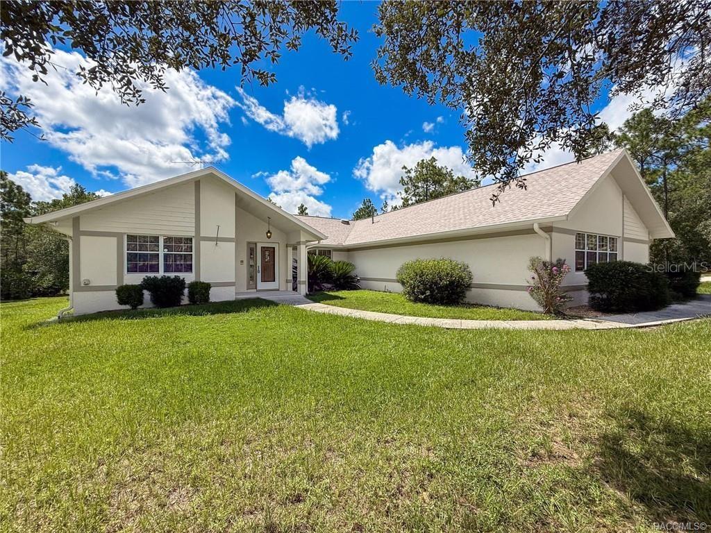 One or more photo(s) has been virtually staged. Experience the best of Florida living in the highly desirable Pine Ridge Equestrian Community at 5396 W. Pine Ridge Boulevard, Beverly Hills, Florida. This beautiful and spacious 3-bedroom, 2.5-bath home offers 2,228 sq. ft. of living space, 3742 sqft total on 1.43 acres, tucked away in a private, natural wooded setting. The oversized, screened 3-car garage with workbench and laminate flooring provides abundant storage, complemented by three additional sheds—two with power. Inside, you’ll find new laminate flooring throughout, fresh interior and exterior paint, and plenty of natural light from skylights. The open great room features built-in bookshelves and flows seamlessly into the large dining area. The well-equipped kitchen offers plentiful cabinetry, a cozy eat-in space, and views of the resort-style outdoor area. Step outside to your private oasis: a 16x30 solar-heated pool with spa and shade screen, a poolside bar, and an expansive 42x47 screened lanai—perfect for entertaining. The pool bath, conveniently accessible from both the laundry room and the lanai, adds to the home’s functionality. Peace of mind comes with the 2021 roof, new HVAC with dehumidifier, new gutters, updated septic system, and new well fed irrigation irrigation system. The master suite includes dual walk-in closets, double vanities, a sunken tub, and direct pool access. The home is also generator-ready with a brand new hot water heater. Pine Ridge Estates is an equestrian paradise with over 28 miles of riding trails, community stables, arenas, and pastures. Residents also enjoy tennis courts, pickleball, shuffleboard, and a community center. Conveniently located near shopping, dining, and medical facilities, and just a short drive to the Gulf for boating and fishing adventures. Don’t miss your chance to own a piece of the Pine Ridge lifestyle—where spacious homes, riding trails, and natural beauty meet!