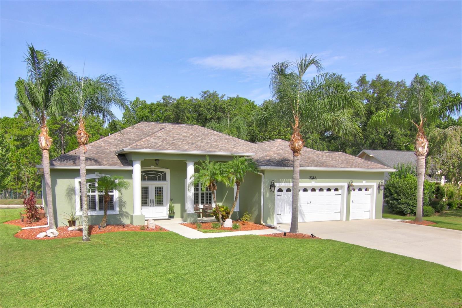 On a quiet dead-end street in the guard-gated Spruce Creek Fly-In community, this four-bedroom, two-bath home with charming curb appeal has been thoughtfully maintained and upgraded. Offering a blend of comfort and functionality, highlights include tile floors throughout, 10-foot ceilings, plantation shutters, upgraded windows and doors, and a spacious air-conditioned garage with a golf cart bay. A welcoming dual-door entryway opens to the living and dining areas, which transition to the lanai through triple-slider glass doors, allowing natural light and views of the backyard and pond. The adjoining kitchen is equipped with a pantry, modern appliances, under-counter lighting, a breakfast bar and a dining nook. The primary suite with sliders to the patio is designed with two closets, dual vanities, a relaxing garden tub and a walk-in shower. A nearby bedroom is ideal for use as an office or den, while two additional bedrooms and a bath are on opposite side of the home. Storm shutters are provided including an accordion shutter for the back patio. Other features include a textured driveway coating, overhead garage storage racks, a central vacuum system, and a safe room closet with concrete block walls and ceiling, and a steel door. The roof was replaced in 2017 and the air-conditioner was replaced in 2019. Living in Spruce Creek Fly-In offers exceptional amenities such as private golf-cart friendly streets, a playground, parks, onsite management, and various businesses including a public restaurant and a hair salon. There is optional membership to a country club that provides access to pickleball, tennis, golf, exercise facilities, a pool and a restaurant. The community is conveniently near stores, restaurants, Port Orange area schools, recreation areas and is a short drive to the beach. Additionally, there is a private resident-use airport with a 4,000-foot paved runway, paved taxiways, a GPS approach and aviation services available.