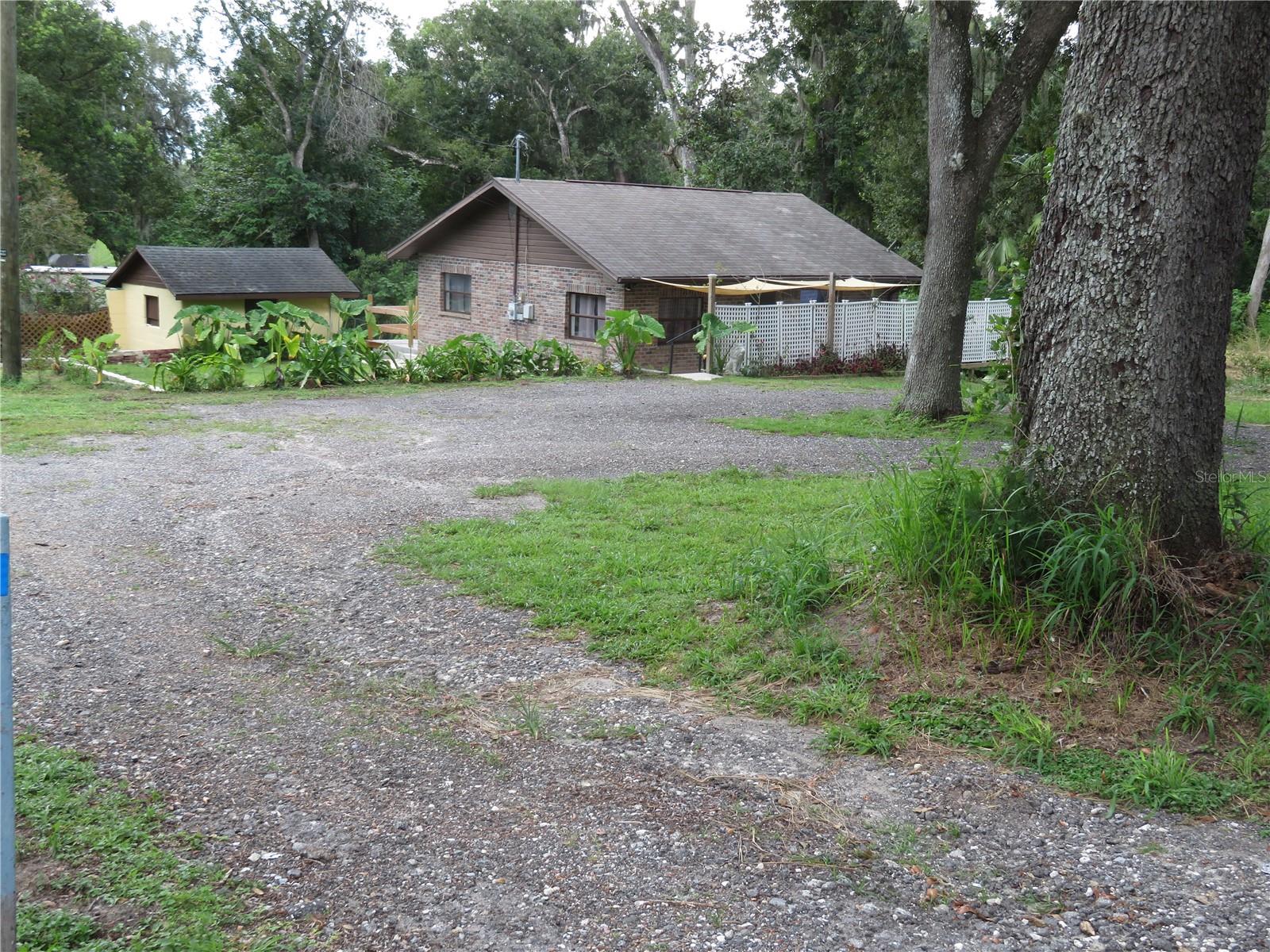 Charming Florida Cottage on 0.52 Acre Parcel – Circular Drive, RV Hook-Up, No HOA/CDDs, Near Mirada Lagoon!
Live Free & Play Big. Florida charm meets backyard Bliss with room for all your toys.
Welcome to this beautifully updated 2-bed, 1-bath concrete block home on a spacious 0.52-acre parcel seconds from the highly desired original city of San Antonio, FL. Featuring a circular driveway, 30-amp RV hook-up, and NO HOA, NO CDD fees, this home offers the freedom and flexibility Florida buyers crave.
Inside, enjoy new flooring and a stylish granite/marble bathroom. Step out front to a cozy partially covered patio, or head out back to your private sundeck, perfect for relaxing under the trees.
The pet friendly fenced backyard provides mature landscaping, RV/boat parking, and a detached utility room for bonus storage or workspace.
Located just minutes from Mirada Lagoon, a 15+ acre amusement-style man-made lagoon offering kayaking, floating pickle ball courts, obstacle courses, and bungalow rentals—plus easy access to Publix, I-75, restaurants, the Pasco County Fairgrounds, and Downtown Dade City. A true gem for those seeking space, charm, and lifestyle!