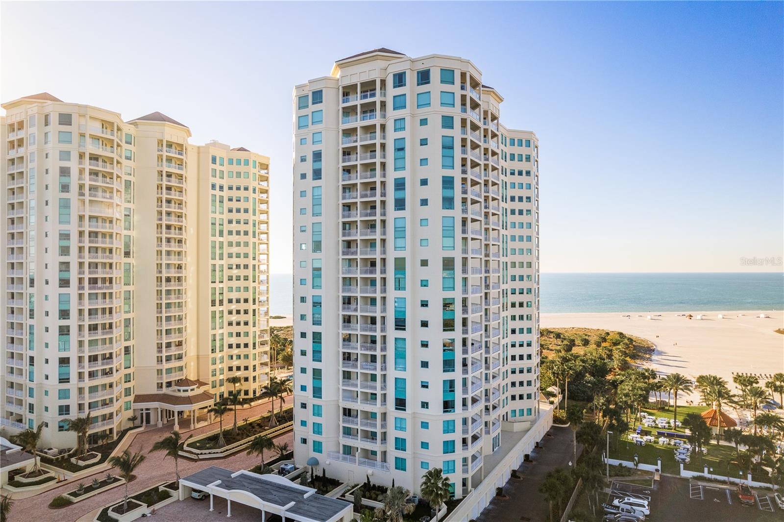Gulf & Intracoastal Paradise Awaits! Prepare to be swept away by this stunning 3-bedroom, 2-bath Gulf-front condo at the prestigious Grande on Clearwater Beach. This show-stopping residence combines modern upgrades, opulent finishes, and million-dollar views that surround you from every angle.
The interior has been freshly updated with custom wood cabinetry, soft lighting, extra-large baseboards, and new flooring throughout. The chef’s dream kitchen features quartz countertops, upgraded appliances, a wine fridge, and ample storage space. The spacious primary suite includes a walk-in closet, linen closet, and a luxurious en-suite bath with double vanities, a large glass shower, and more custom cabinetry. The generously sized second bedroom also includes a walk-in closet, while the third bedroom offers flexibility, easily transitioning into a den or home office. Major upgrades include hurricane-rated sliders (2018), HVAC (2020), water heater (2021), and a brand-new electrical panel (2025).
Step outside to the wrap-around balcony, where you’ll enjoy breathtaking, panoramic vistas of the Gulf, Intracoastal, Clearwater Beach, bridges, and Downtown Clearwater. Wake up to brilliant sunrises and wind down with sparkling nightscapes over the water.
The Grande offers resort-style amenities across 14 landscaped acres, including two sparkling pools, a huge Jacuzzi, 24/7 gated security, concierge service, private beach access, fitness centers, clubhouses, outdoor kitchens, and entertainment spaces. Additional amenities include dog-walk areas, covered parking, and reduced membership at the Clearwater Sailing Center just across the street.
Located just steps from dining, shopping, and the beach trolley, with quick access to both Tampa and St. Pete airports, this condo offers the best of beachfront living.
Don’t just dream it—live it! Call today to schedule your private tour of this Gulf-front treasure at The Grande.