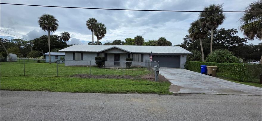 Welcome to this solid Concrete block home located on a peaceful corner lot, located within the city limits. This home features 2 bedrooms, 2 bathrooms with a 2 car garage. With an open concept kitchen and living room, It has  a large eat-at bar. appliances are included.  The garage has additional interior lockable storage, hurricane rated garage door. Bring your pets, The entire property is fenced in with 5ft chainlink fence. The property comes with huirricane shutters, It has a screened back porch with a bar, TV, and Fridge. large laundry room, appliances included.  A nice workshop out back with a lean-to for lawn equipment or your motorcycles. This home has a 2019 26 gauge galvalume metal roof, a 2014 A/C condensor, and a 2022 air handler.
Newer W/H.  Convenient location close to schools, shopping, and city amenties.