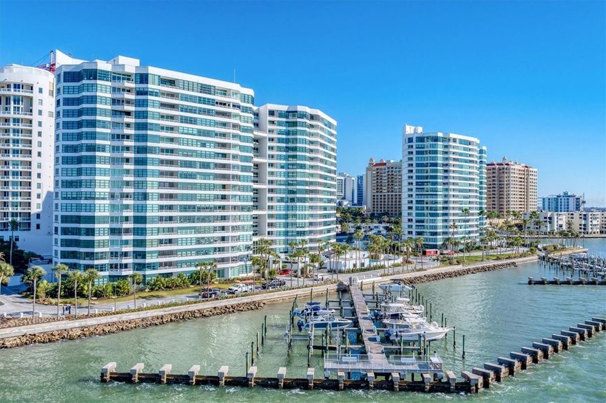 With Sarasota’s endless sunshine and breathtaking coastal vistas, the views from this residence truly go on forever. From the 18th floor, enjoy full, unobstructed panoramas of Sarasota Bay stretching all the way to the Gulf of Mexico on the horizon—views attainable only from the 18th and 19th floors, where residences are rarely available.

This exceptional home has been completely remodeled to a refined, contemporary living space. The main living areas and kitchen feature select UA Grecian Series Natural Hickory wood flooring, adding warmth and sophistication throughout.

The renovated kitchen and two bathrooms showcase soft-close European-hinge cabinetry and granite countertops. The kitchen is equipped with high-end KitchenAid appliances, including a refrigerator, convection oven, microwave, cooktop, vent hood, and dishwasher. A full-size stacked GE washer and dryer are conveniently and discreetly integrated into the kitchen design.

Thoughtful upgrades enhance both comfort and wellness, including a REME HALO whole-home air purification system, Everpure commercial-grade water filter in the kitchen, and a Smith Proline commercial-grade water heater. Recently replaced Plaza HBP Low-E sliding glass doors (Miami-Dade rated) frame the spectacular views, while Llumar Vista security window film—with a lifetime guarantee—adds peace of mind in the primary bedroom.

Additional custom touches include a floating bar in the living room and elegant Allure window shades, with motorized shades in the primary bedroom.

The Condo on the Bay community offers a wide array of amenities exclusively for its residents and guests of both Towers I and II. These amenities include: • 2 Swimming Pools - North and South, • 4 Lighted Pickleball Courts, • Lighted Tennis Courts, • Exercise Facilities & Sauna Rooms, • Boat Docks, Kayak Racks, and Fishing Piers - North and South. This active community also participate in many social events such as Mahjongg & card games, discussion & screening, family/group gatherings and fellowship, and Happy Hour. There is something here for everyone! It is time to experience a luxurious urban life from the 18th floor of Tower II, in the pulsing heart of Downtown Sarasota!