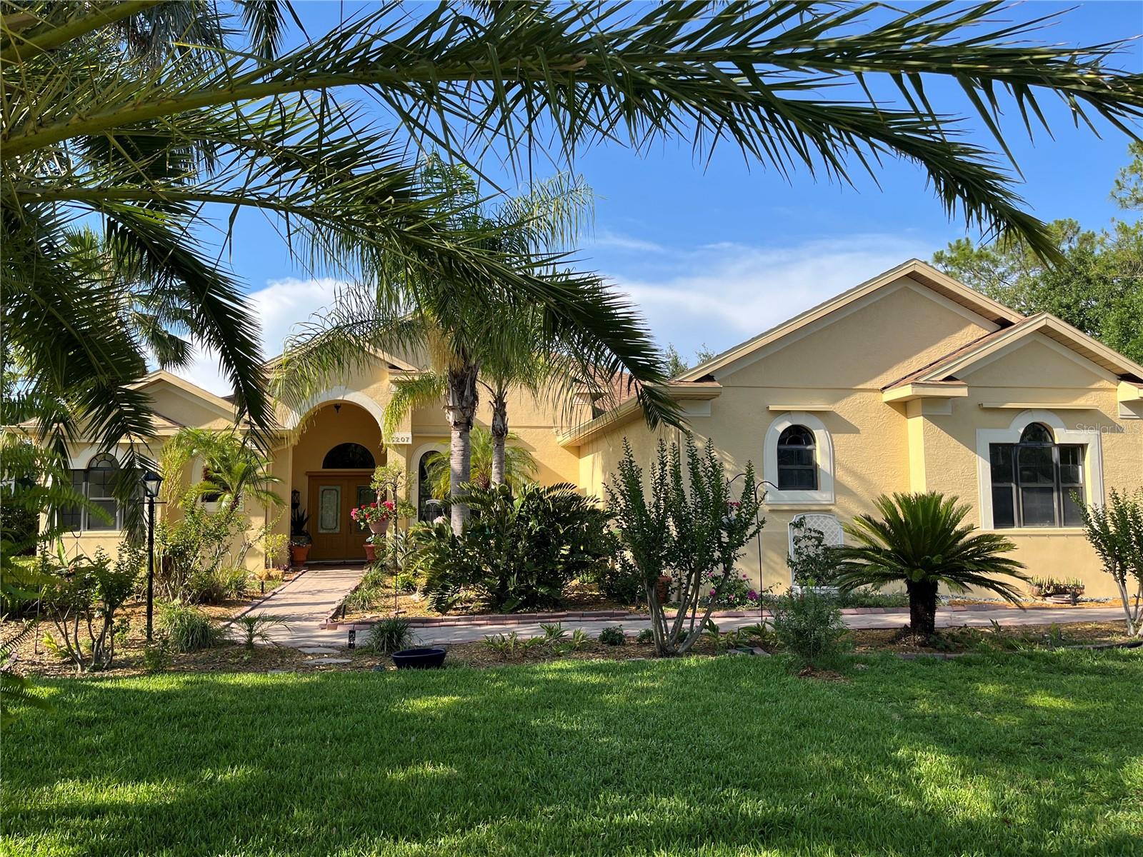 Enveloped within the scenes & sounds of nature & wildlife-Sit back, relax, & enjoy the beauty from outside & in with this 3 bed + huge den/4th bedroom, non cookie cutter home located in beautiful Mill Creek. Low HOA & NO CDD. New roof in January 2025! Freshly painted exterior, inside garage & interior including walls, baseboard, crown, trim & doors. Enormous potential with a hard to find large side yard to add a shop or park an RV/boat. The oversized side load 3 car garage includes a lighted/tiled closet with shelving. Perfectly positioned on the widest centered area of the pond, you will have a front row, panoramic seat to watch the Great Blue Heron glide in for a soft landing, the Eagles soaring then diving for a fresh fish lunch, & the ducks that never seem to tire of swimming/splashing & playing. Inside, delight in architectural features such as crown molding, 8 ft doors, 10/12 foot ceilings, double trays, niches & more. NO CARPET-all of the bedrooms have engineered hardwood floors & tile everywhere else. The great room has sliders overlooking the large unique L shaped lanai & your view of the pond & mature landscaping/trees. Split bedrooms with the primary on one side, 2nd & 3rd on the other, & den/4th bed in the back. The primary bedroom has patio doors to the lanai & 2 custom built walk in closets. The primary bath has a walk in shower with bench, huge jetted whirlpool tub, 2 sinks, storage closet & separate water closet. There are clerestory "sliver" windows in the primary bedroom, bath & den to add light & visual aesthetics without sacrificing privacy or wall space. The 2nd or guest bath is located between the 2nd/3rd bedrooms. The 2nd bath has a shower/tub combination. The 3rd bath has a walk in shower & storage closet. In the back off of the kitchen there is a hallway leading to the Den/4th bedroom. If you want to make it an official 4th bedroom there is a nook space to build out a closet. Pocket doors can completely close this area off for an Inlaw suite with access to the lanai, the 3rd bathroom, & the 3rd bedroom. The 3rd bedroom also has a door leading to the hallway where the 2nd bath/2nd bedroom are located. The large kitchen has new appliances in 2024, closet pantry, island, & tons of cabinet (bottom pull out shelving) & countertop space. The eating area in the kitchen has an aquarium window. The formal dining room looks out to lush landscaping & there is a wet bar off of the dining room with cabinets, sink, & small refrigerator. The laundry room has cabinets, countertop space & a utility sink. Lanai has pavers, fans, perfect spot for a grill, or add an outdoor kitchen, plumbing is already installed. Outside you will delight in the various species of trees, shrubs, fruit trees, plants, & flowers including exotic flowering trees & perennials with plenty of extra room for a garden. Irrigation with reclaimed water, HVAC age 2020, Water heater age 2016. Metal & acrylic hurricane shutters in garage. Mill Creek is a great community to call home with its larger lot sizes, mature landscaping, & location-just outside Lakewood Ranch in unincorporated East Manatee County. I75, Costco etc...are about 6 miles away. Once the 44th street extension is completed a trip to the beaches will be a quicker drive. Welcome home!