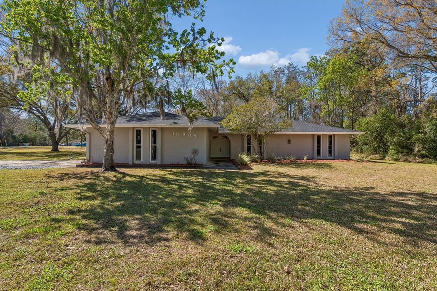 Welcome to Golden Acres, where privacy, space, and modern updates come together beautifully. This fully remodeled 3 bedroom, 2 bath pool home offers exceptional curb appeal with mature trees, fresh landscaping, brand-new exterior paint, a new roof, newer windows, and a spacious 2 car garage.
Inside, you’ll find a bright and open floor plan with expansive living areas and flexible layout options. The remodeled kitchen features white soft close wood cabinetry, fantasy brown granite countertops, and abundant workspace, flowing seamlessly into the main living space. 
The split bedroom layout includes two generously sized secondary bedrooms and a beautifully updated hall bath with new tile and modern finishes. The oversized primary suite easily accommodates a king sized bed, offers a walk in closet, double French doors leading to the pool area, and a private bath with double vanity and updated shower. Step outside to your private backyard retreat featuring an expansive covered patio spanning nearly the entire length of the home, complete with ceiling fans and lighting, plus a large swimming pool ideal for entertaining. The lot provides excellent privacy with wooded surroundings and generous side yard space, and includes a matching storage shed. This move in ready Golden Acres pool home offers space, style, and privacy — all in one exceptional property. (ROOF-2026)(A/C-2025)(W/H-2015)