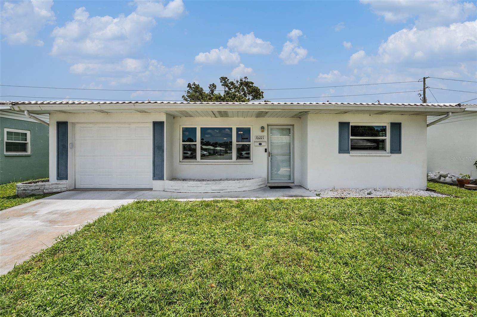 Welcome to easy Florida living in the desirable 55+ community of Springwood Villas! This charming 2-bedroom, 2-bath home offers comfort and convenience, including a 2023 metal roof and 2023 hurricane-impact windows. Enjoy a spacious living room/dining room combo, with ceiling fans throughout. The kitchen features matching appliances and plenty of cabinet space. Tile flooring flows through the main living areas, while both bedrooms offer cozy carpet. The primary bedroom has a private bathroom and a walk-in closet for added convenience. Relax year-round in the screened-in lanai, or take advantage of the one-car garage for parking and extra storage. Community amenities include a pool, shuffleboard courts, and a monthly fee that covers cable, internet, water, trash, and more - making maintenance a breeze. Ideally located near dining, shopping, and everyday essentials, this home is the perfect blend of comfort and community. Don't miss your chance to enjoy the low-maintenance lifestyle you’ve been looking for!