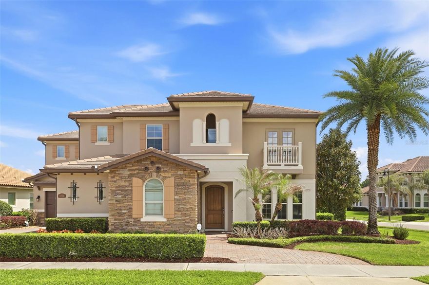 Presenting a rare opportunity to own an exceptional resort-style estate, perfectly positioned on an oversized corner lot within the highly sought-after gated community of Steeple Chase. From the moment you arrive, the home’s impeccable craftsmanship, architectural detail, and curated upgrades set a tone of refined luxury. Step inside to a thoughtfully designed open-concept floor plan, where soaring ceilings and abundant natural light create an atmosphere that is both grand and inviting. Elegant formal living and dining spaces provide the perfect setting for sophisticated entertaining. At the heart of the home, the gourmet chef’s kitchen is as functional as it is stunning, featuring premium stainless steel GE Monogram appliances, a gas cooktop, expansive center island, farmhouse sink, walk-in pantry, and generous counter space. Seamlessly overlooking the spacious great room, this space is ideal for both everyday living and effortless hosting. A truly distinctive highlight is the private wine lounge and bar, complete with custom cabinetry, an oversized wine refrigerator, and multiple beer taps—an entertainer’s dream and a guaranteed conversation piece. The first-floor owner’s suite offers a private retreat, showcasing tray ceilings, expansive walk-in closets, and a spa-inspired bath with a luxurious walk-in shower and separate soaking tub. Direct access to the outdoor living area from the Owner’s Suite enhances the indoor-outdoor lifestyle. A dedicated office on the main level, featuring custom built-ins and wood flooring, offers flexibility as a guest suite if needed. Upstairs, you’ll find four additional bedrooms, three full bathrooms, and a versatile loft with a custom built-in wall unit. An oversized bedroom presents the opportunity to create a private theater or game room tailored to your lifestyle. Function meets convenience with a well-appointed laundry room connecting to a single-car garage, while a separate two-car garage offers additional storage, including ceiling-mounted racks. The outdoor living space is nothing short of extraordinary—reminiscent of a luxury resort. The expansive covered lanai features a tongue-and-groove wood ceiling and a fully equipped summer kitchen with natural gas appliances, refrigerator, and elegant gas-lit coach lighting. Enjoy the saltwater pool and heated spa, or entertain at the custom outdoor bar, complete with dual beer taps, granite countertops, stainless storage, and ample seating. Lush, mature Podocarpus hedging creates a private, serene backdrop, while additional enhancements such as surround sound and a natural mosquito misting system ensure year-round comfort and enjoyment. Ideally located near top-rated schools, world-class dining, premier shopping, and with convenient access to major Central Florida highways, this home offers the perfect blend of luxury, comfort, and location. This is a truly rare offering—schedule your private showing today. Note: Property may be under audio and visual surveillance.