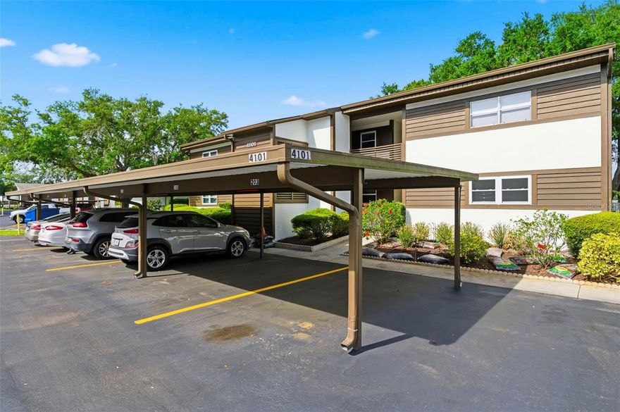 One or more photo(s) has been virtually staged. WELCOME TO YOUR SWEET HOME at 4101 Passport Ln #203, New Port Richey, FL in the WONDERFUL 55+ community of Woodtrail Condominiums. This 2nd level unit has an OPEN FLOOR PLAN with 1251 heated sqft. As you step through the front door, you will LOVE how BRIGHT & AIRY this home feels! This NICE condo features an OPEN FLOOR PLAN consisting of the foyer, kitchen & dining room & EXTRA LARGE living room. Natural SUNSHINE streams through the multiple windows ILLUMINATING the interior together with the light fixtures. The well-equipped kitchen comes with TILE FLOORS, PLENTIFUL cabinets with hardware, expansive laminate counters, breakfast bar, deep double stainless steel sink, cute fan & appliances including fridge, smooth-top range, microwave, dishwasher & water purification system located under the sink. The MASSIVE living room features a big picture window overlooking greenery & serene views. In fact the living room is so big that it can be designed as a home office, gym, craft room or reading nook. The kitchen, foyer, dining room & bathrooms feature easy to maintain ceramic tiles. The SPACIOUS primary bedroom can easily accommodate king-size furniture & has a ceiling fan, walk-in closet, a SECOND CLOSET with triple mirrored sliding doors & en suite bathroom. The SENSUAL private bathroom consists of a sink, vast countertops, wood vanity, medicine cabinet & a tiled tub/shower combo with DUAL SHOWER HEADS & frosted sliding doors. In this split bedroom plan, the second bedroom & bathroom are located on the opposite wing of the home. The guest king-size bedroom features ample closet space with mirrored sliding doors & ceiling fan. The OVERSIZED second full bathroom has a matching vanity cabinet, exhaust fan, bright light & a tub/shower combo with frosted sliding glass doors & private toilet area. The WASHER & DRYER are included for the LUCKY new buyer. Another WONDERFUL UPDATE: The AC was recently serviced to make sure it is running properly. This condo comes with a reserved CARPORT parking space & personal utility shed located just outside the front door. Low HOA fee of $450/month includes amenities like HEATED pool, clubhouse, gym, private road, cable TV, internet, all exterior lawn/pest maintenance, trash & roof. One small pet is welcome. The Woodtrail condo community hosts many social events like bingo, card games, information sessions and pool parties. Your MARVELOUS condo will faces East so you can enjoy the setting sun painting the sky in VIBRANT COLORS every evening. CRUISE over to DOWNTOWN New Port Richey featuring FANTASTIC restaurants, taverns, festivals, shopping & professional offices. Sims Park is PHENOMENAL for everyone with a playground, splash pad, walking paths along the river & an outdoor amphitheater. The public boat launch is just a few short minutes away where you can take your boat directly to the Gulf of Mexico or enjoy kayaking down the river. Robert K. Rees Beach Park is a few miles away! The City of New Port Richey is BUSTLING & THRIVING! Location is IDEAL near schools, beaches, medical plazas, shopping centers, restaurants, places of worship, airport & tourist attractions. MAKE THIS YOUR FUTURE HOME!